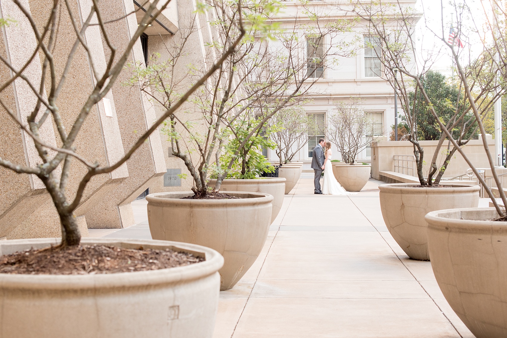 Mikkel Paige Photography photos from a fall wedding at The Stockroom at 230. A picture of the bride and groom in downtown Raleigh with columns and iconic architecture.