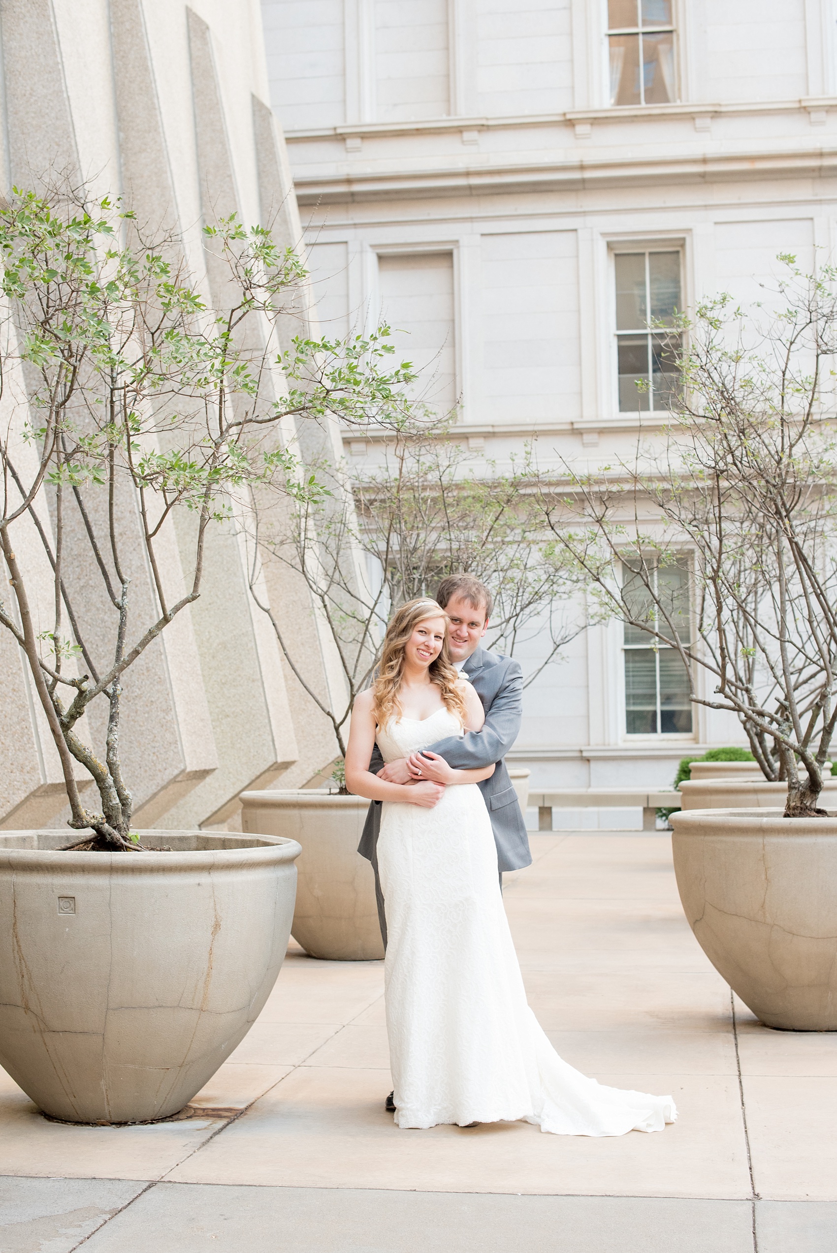 Mikkel Paige Photography photos from a fall wedding at The Stockroom at 230. A picture of the bride and groom in downtown Raleigh with columns and iconic architecture.