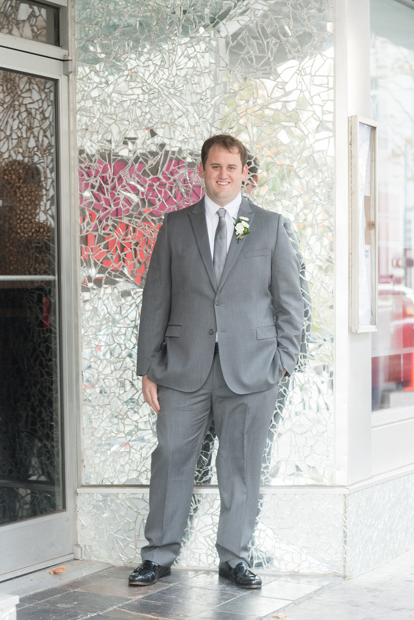 Mikkel Paige Photography photos from a fall wedding at The Stockroom at 230. A unique portrait picture of the groom against mosaic mirrors in downtown Raleigh.