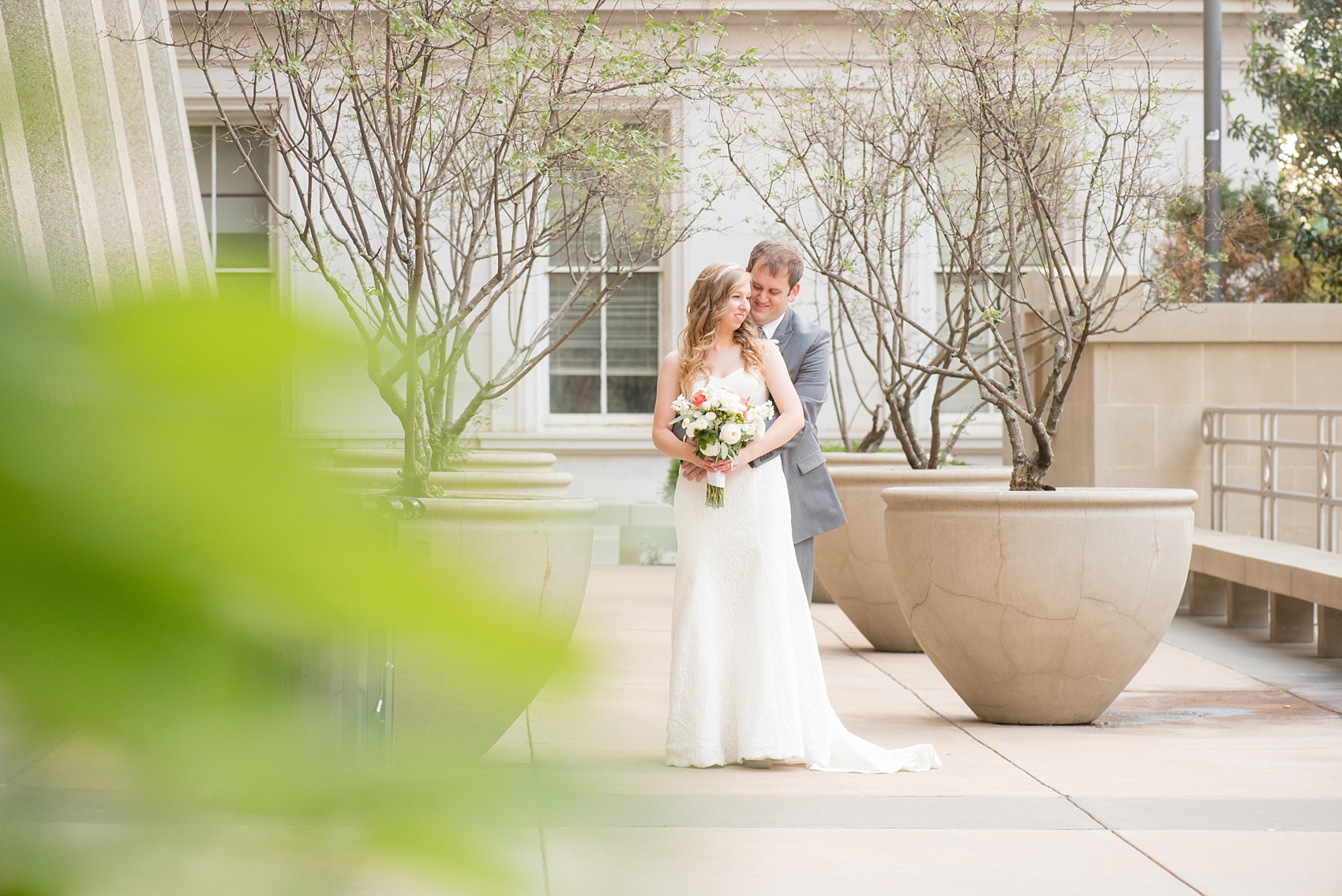 Mikkel Paige Photography photos from a fall wedding at The Stockroom at 230. A picture of the bride and groom in downtown Raleigh with columns and iconic architecture.