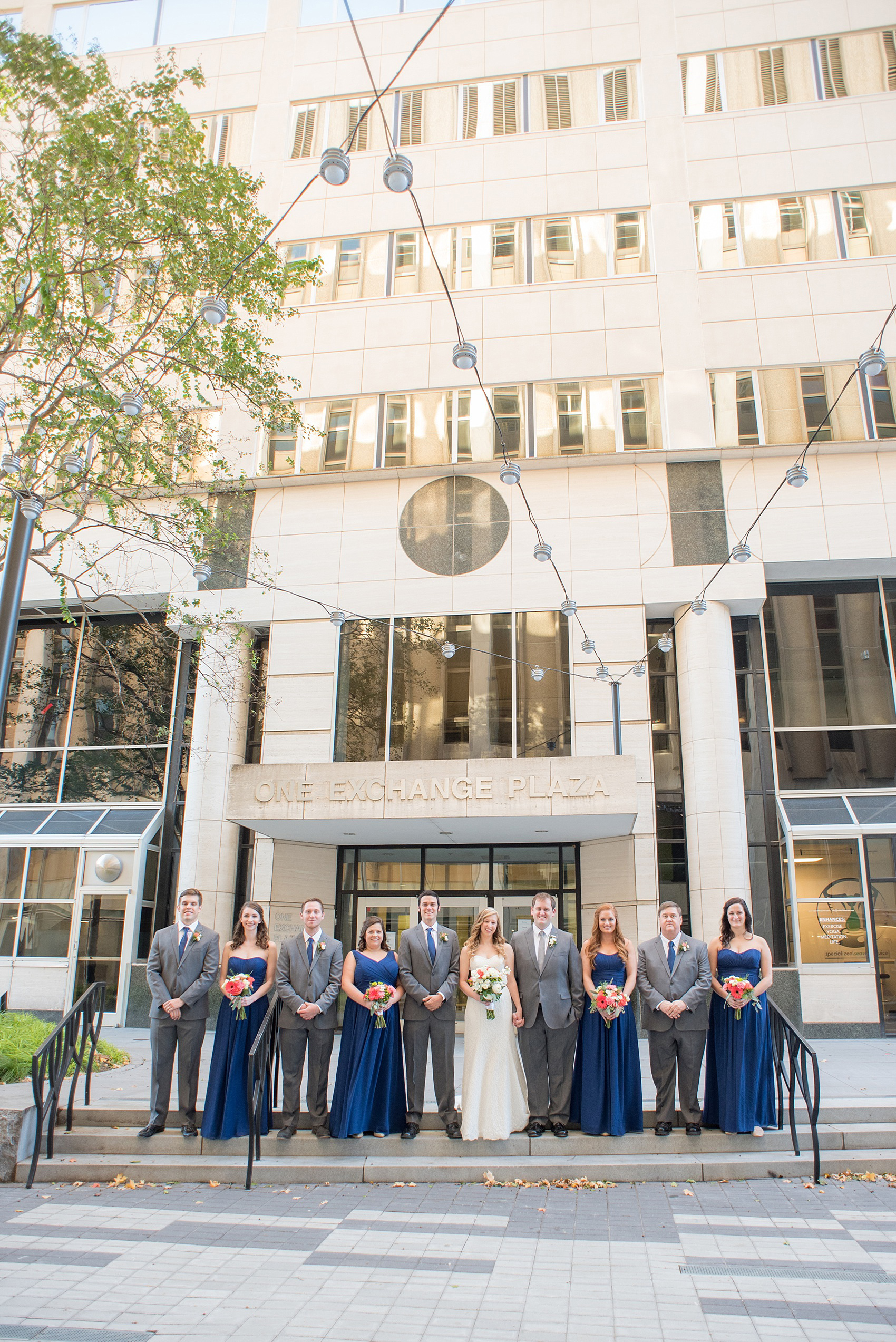 Mikkel Paige Photography photos from a fall wedding at The Stockroom at 230. A unique picture of the bride, groom and their wedding party in downtown Raleigh.