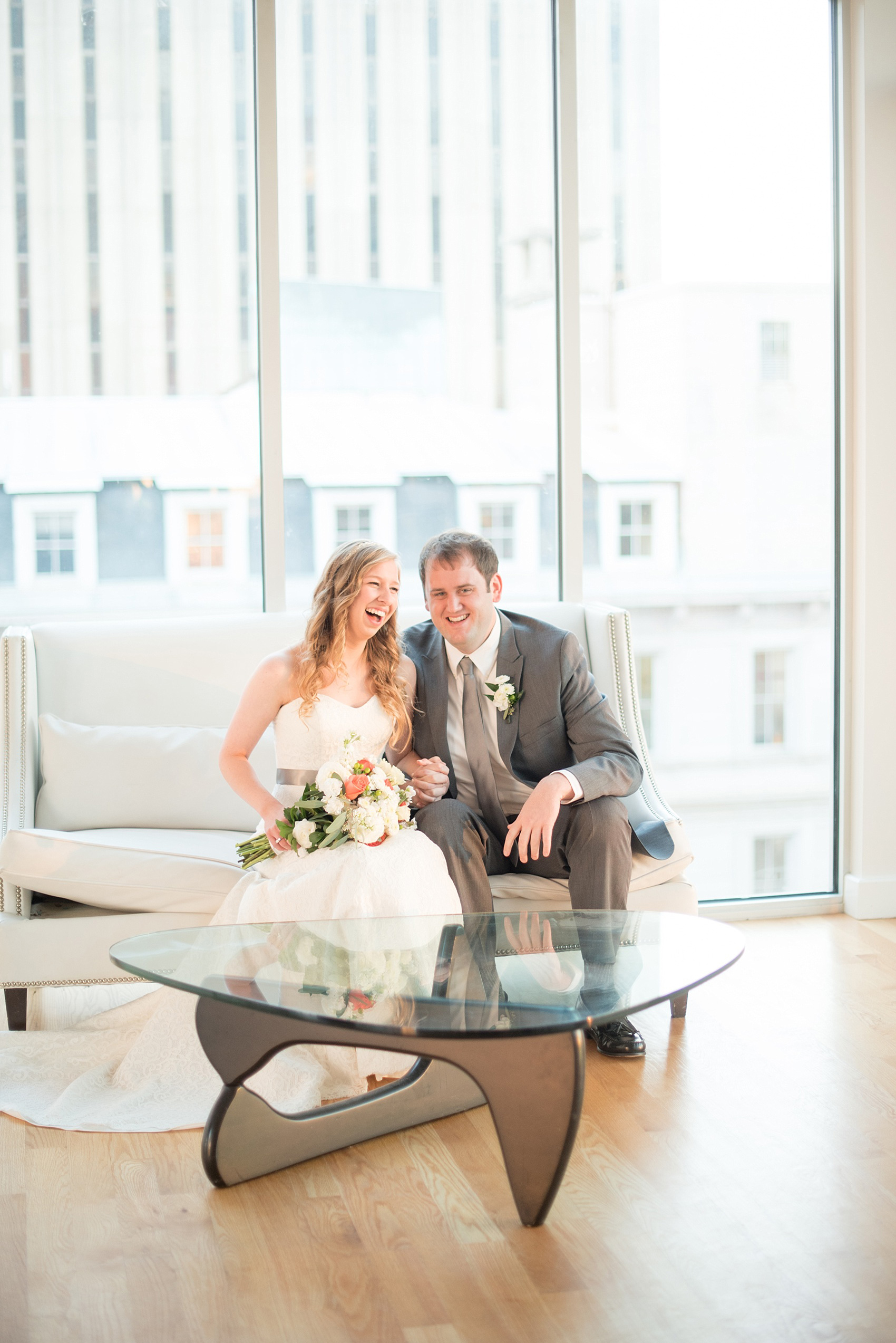 Mikkel Paige Photography photos from The Stockroom at 230 in downtown Raleigh. A cute playful picture of the bride and groom at The Glass Box.