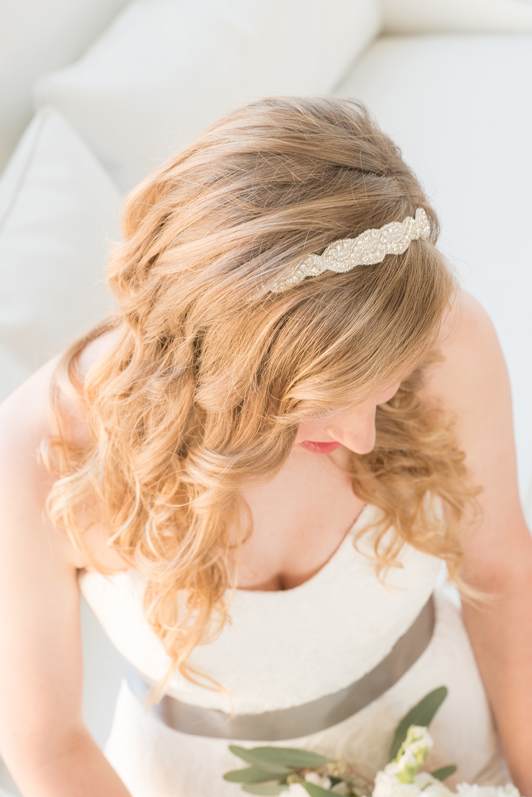 Mikkel Paige Photography photos from The Stockroom at 230 in downtown Raleigh. A beautiful top view picture of the bride's headband and curls at The Glass Box.