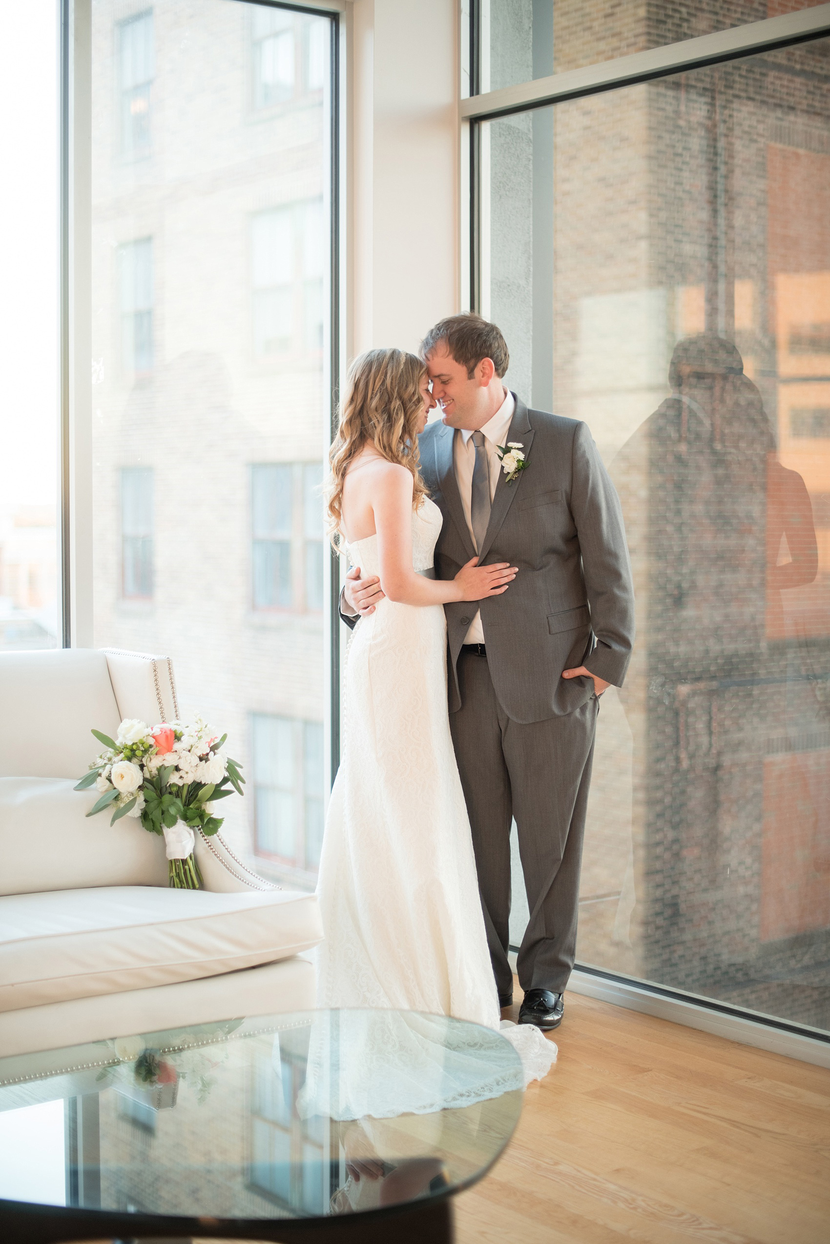 Mikkel Paige Photography photos from The Stockroom at 230 in downtown Raleigh. A cute playful picture of the bride and groom at The Glass Box.