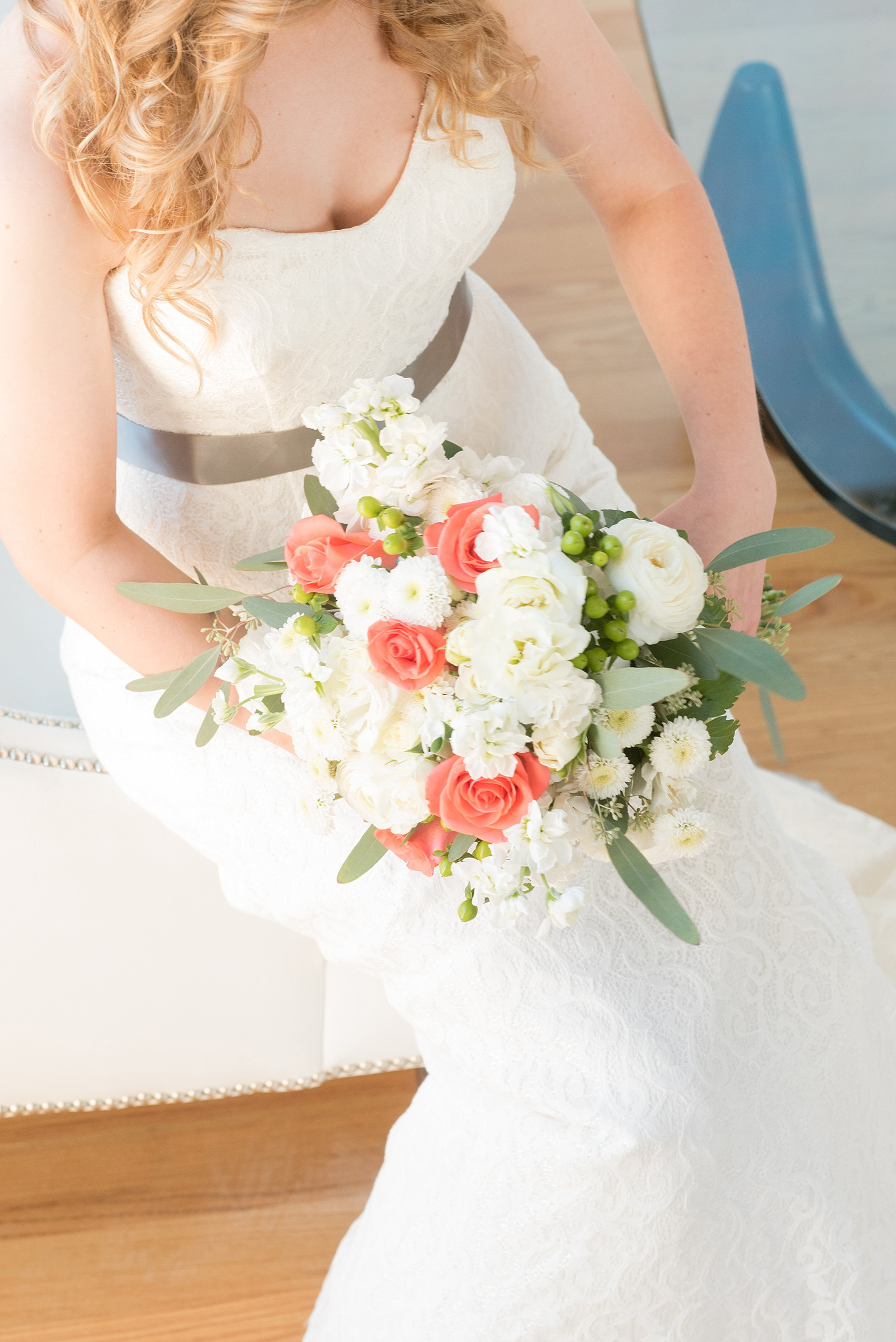 Mikkel Paige Photography photos from The Stockroom at 230 in downtown Raleigh. A beautiful top view picture of the bride's coral and white bouquet at The Glass Box.