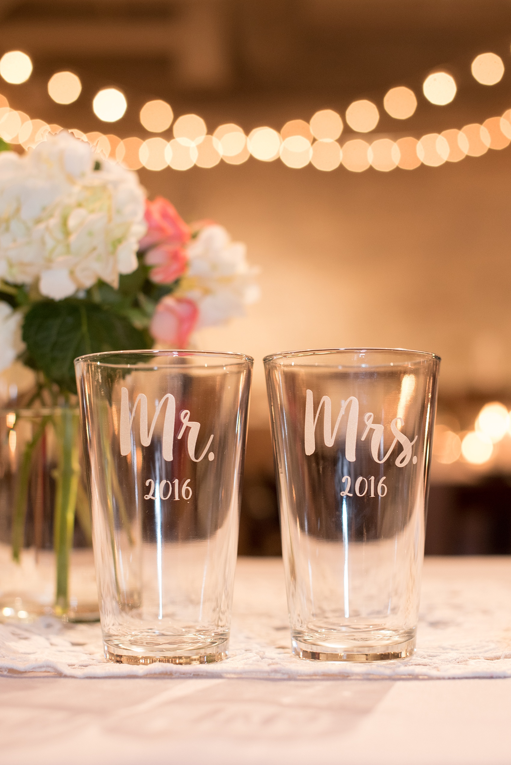 Mikkel Paige Photography photos from a wedding reception at The Stockroom at 230 in Raleigh. A picture of the bride and groom's custom "Mr. and Mrs." pint beer glasses.