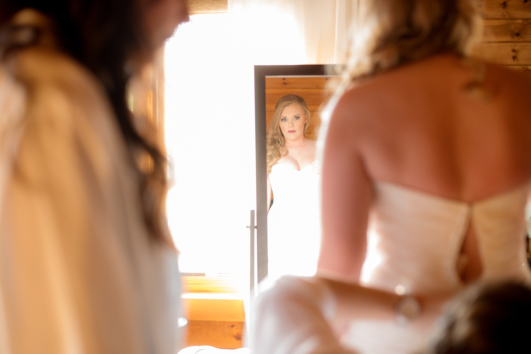 Mikkel Paige Photography photos of a wedding at The Barn at Valahalla in Chapel Hill, NC. The bride prepares for her first look in a rustic room.