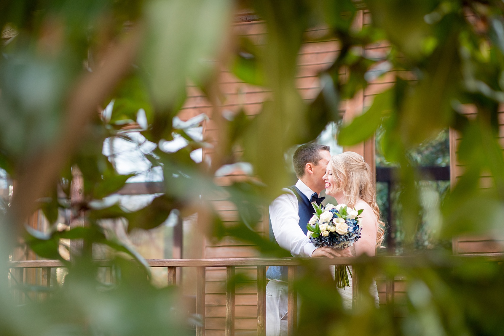 Mikkel Paige Photography photos of a wedding at The Barn at Valahalla in Chapel Hill, NC. The bride and groom during golden hour sunset through southern magnolia tree leaves.