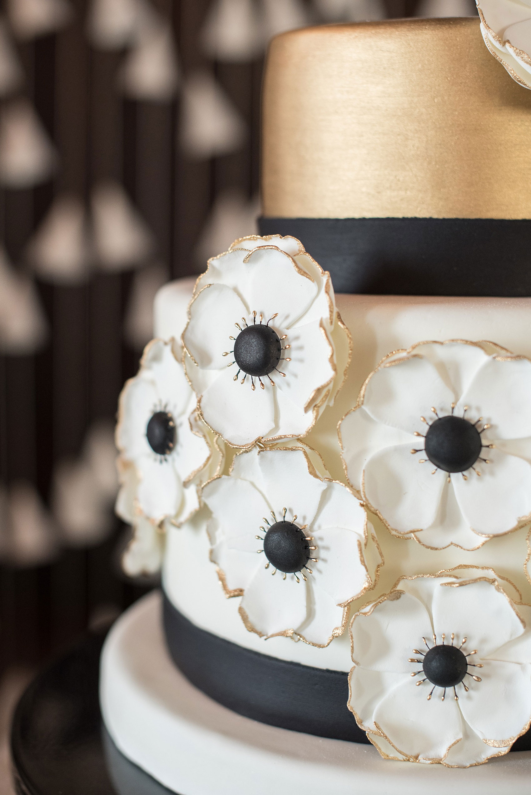 Mikkel Paige Photography pictures of a Raleigh, NC wedding at All Saints Chapel. White, gold and black small wedding cake inspiration with anemone sugar flowers by Edible Art.