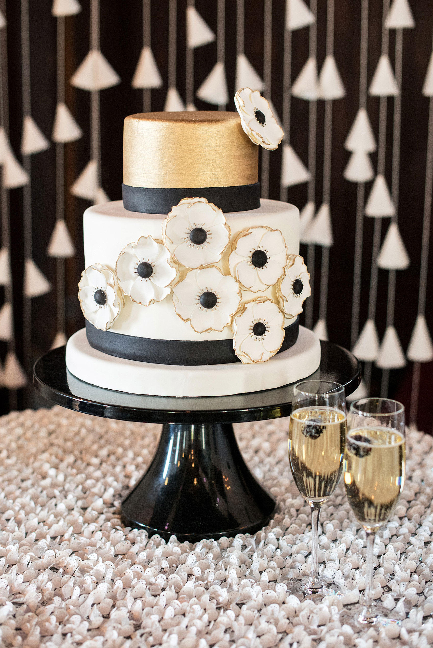 Mikkel Paige Photography pictures of a Raleigh, NC wedding at All Saints Chapel. White, gold and black small wedding cake inspiration with anemone sugar flowers by Edible Art.