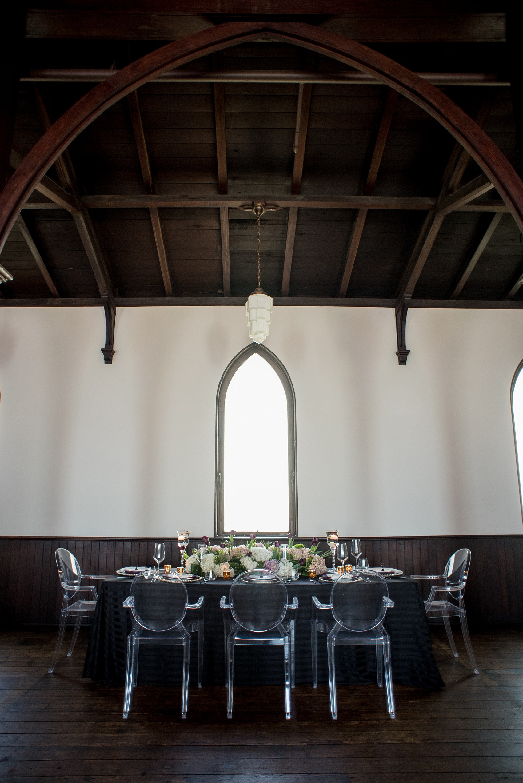 Mikkel Paige Photography pictures of an All Saints Chapel wedding in Raleigh, NC. Purple, black and white inspiration with a modern twist and ghost chairs in a historic venue.