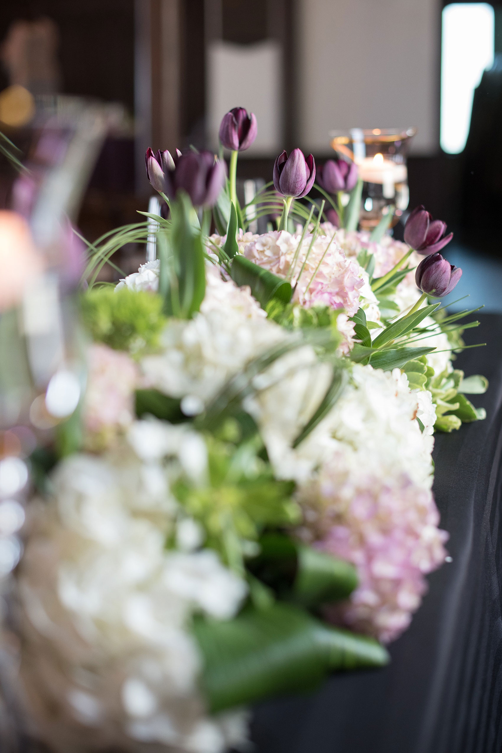 Mikkel Paige Photography pictures of a gay All Saints Chapel wedding in Raleigh, NC. Purple, black and white inspiration with a modern twist and lush tulips and spring flowers by Blossom Artistry in a historic venue.