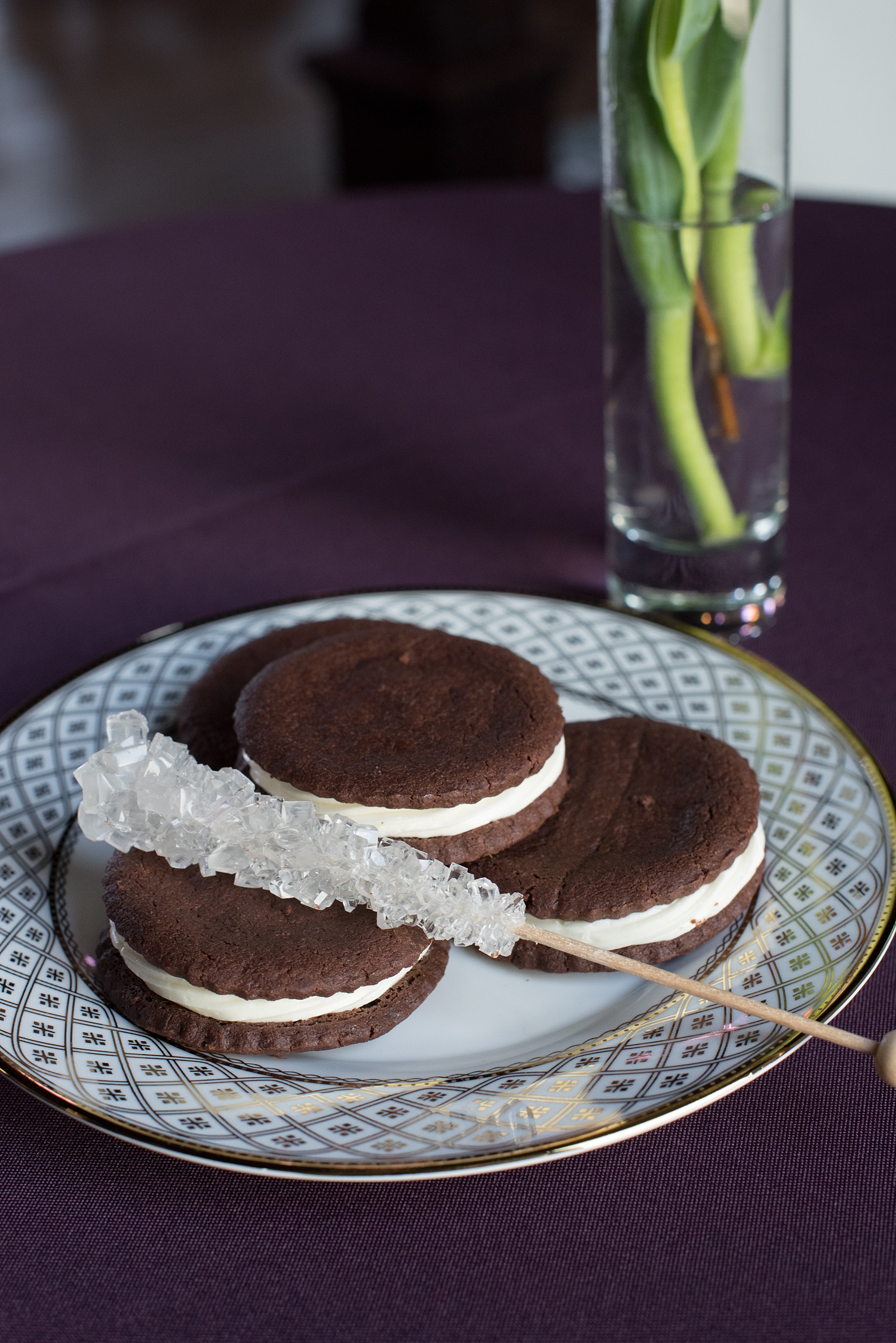 Mikkel Paige Photography pictures of a gay All Saints Chapel wedding in Raleigh, NC. Purple, black and white inspiration with a modern twist and gold accents. Chocolate whoopie pie desserts are accented by clear rock candy sticks.