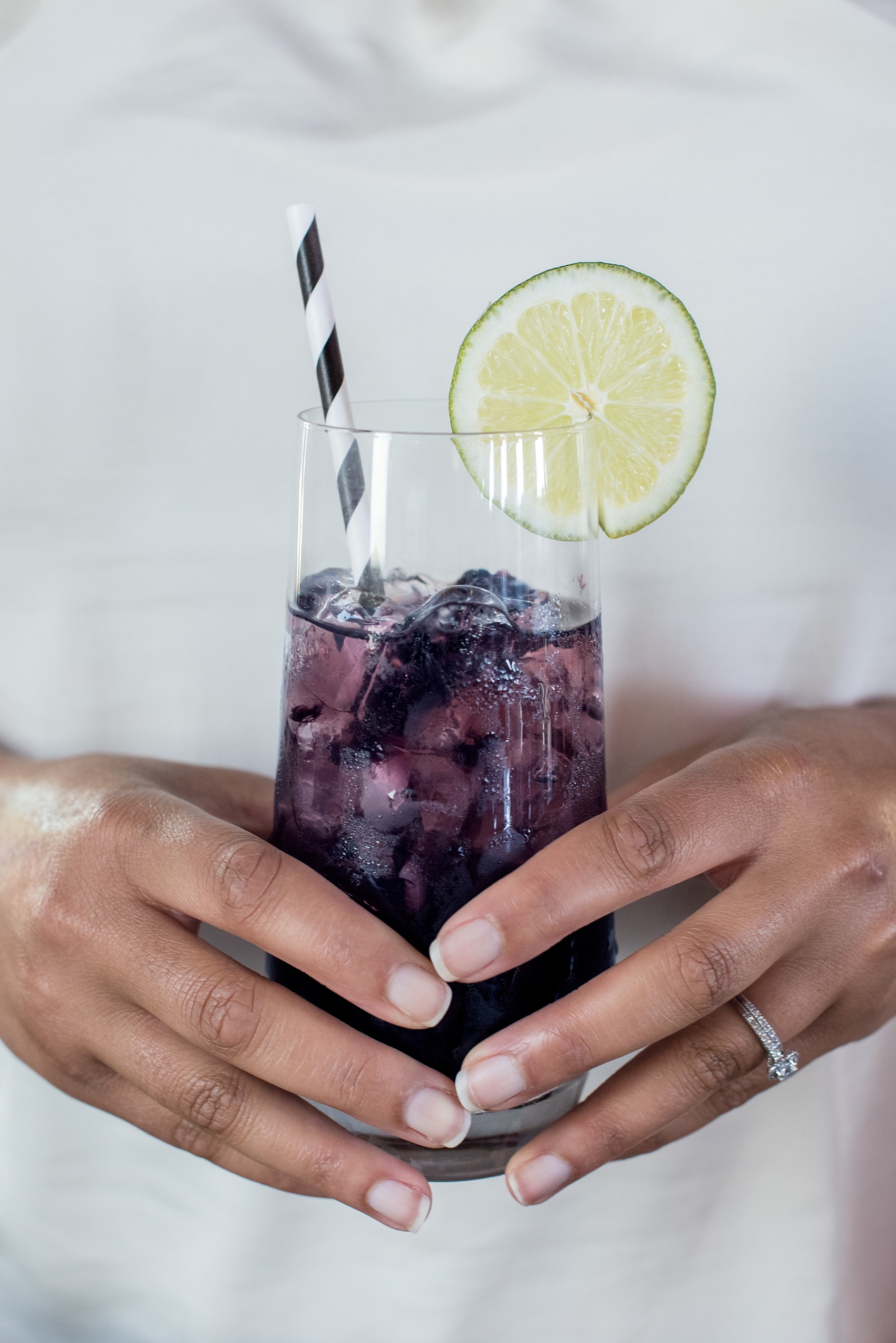 Mikkel Paige Photography pictures of a Raleigh, NC wedding at All Saints Chapel. Purple cocktail inspiration with black and white striped straw and lime by On the Rocks Bartending.