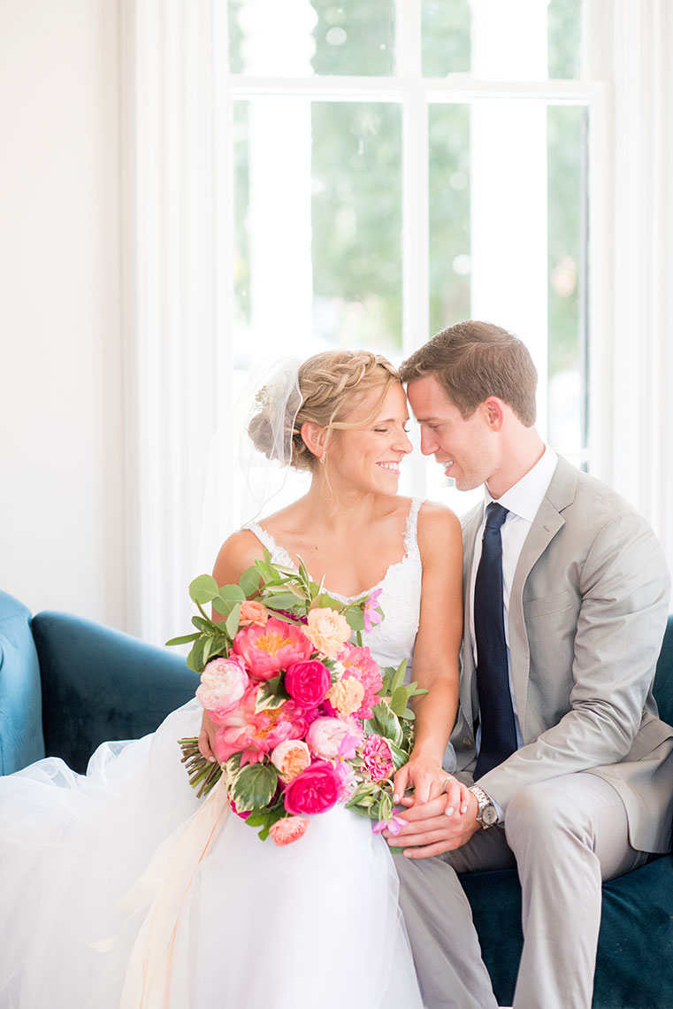 Mikkel Paige Photography photos of a wedding at Merrimon-Wynne House in downtown Raleigh, North Carolina with the couple on colorful furniture.