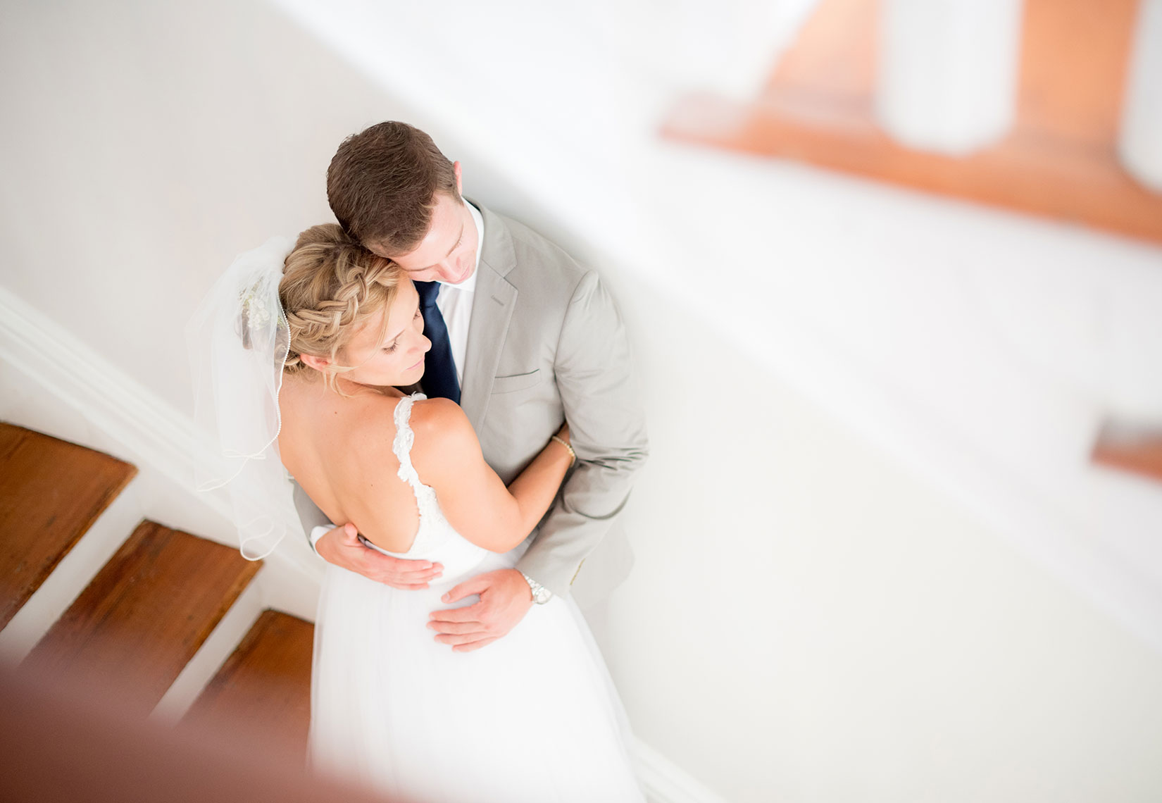 Mikkel Paige Photography photos of a wedding at Merrimon-Wynne House in downtown Raleigh. Portrait of the bride and groom on the southern home's iconic staircase.