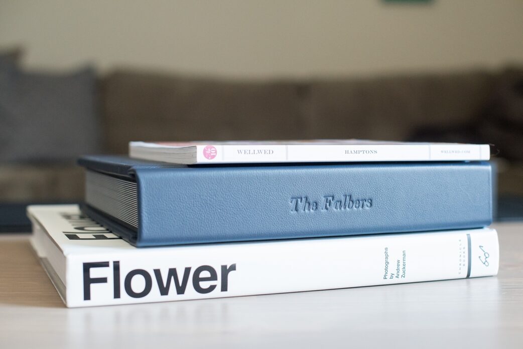 Mikkel Paige Photography photos of a navy blue leather Madera wedding album. Pearl River Hilton wedding - album has debossing on the spine.