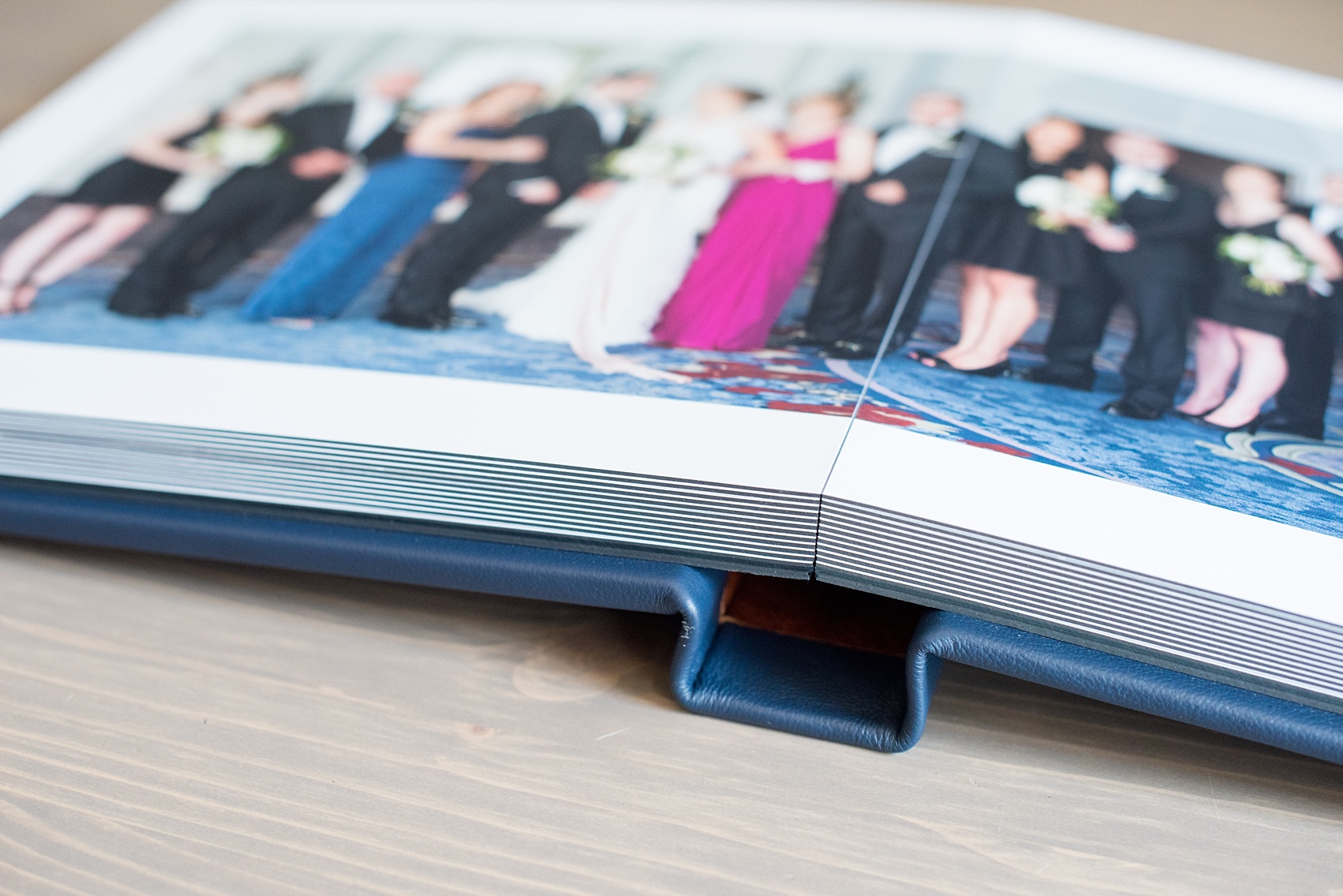 Mikkel Paige Photography photos of a navy blue leather Madera wedding album with thick pages. Pearl River Hilton wedding.