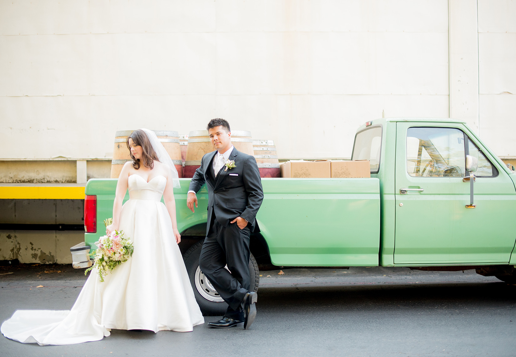 Mikkel Paige Photography photos a wedding at Testarossa Winery in Los Gatos, California with an iconic image of the bride and groom against a mint green vintage pickup truck.