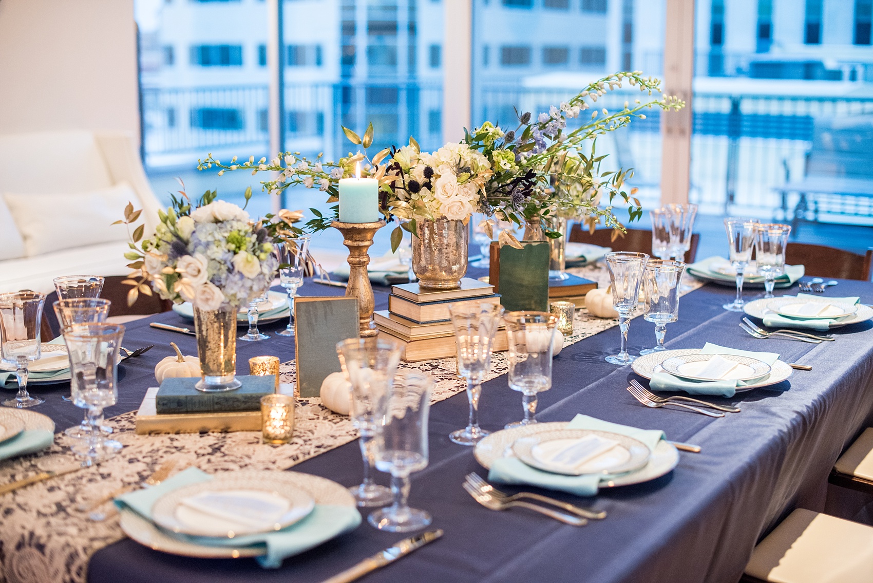 Mikkel Paige Photography photos at The Glass Box in downtown Raleigh. Fall flowers for a bookclub meeting with blue and white centerpieces by Eclectic Sage in pretty mercury glass vases.