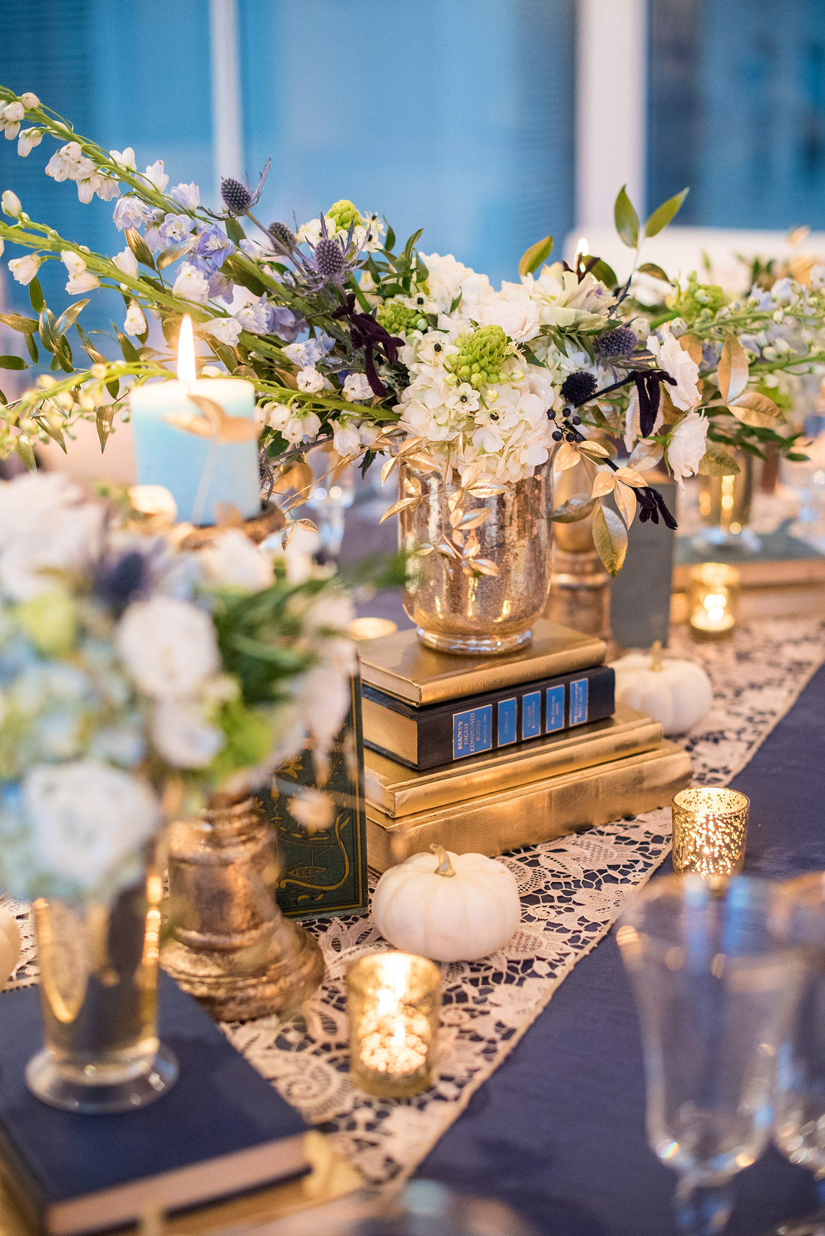 Mikkel Paige Photography photos at The Glass Box in downtown Raleigh. Fall flowers for a bookclub meeting with blue and white centerpieces by Eclectic Sage in pretty mercury glass vases.