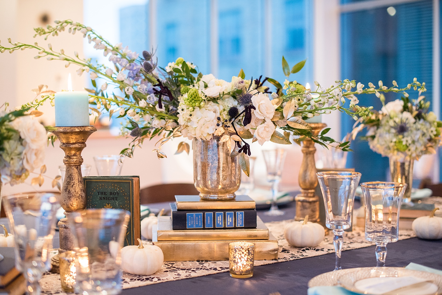 Mikkel Paige Photography photos at The Glass Box in downtown Raleigh. Fall flowers for a bookclub meeting with blue and white centerpieces by Eclectic Sage in pretty mercury glass vases.