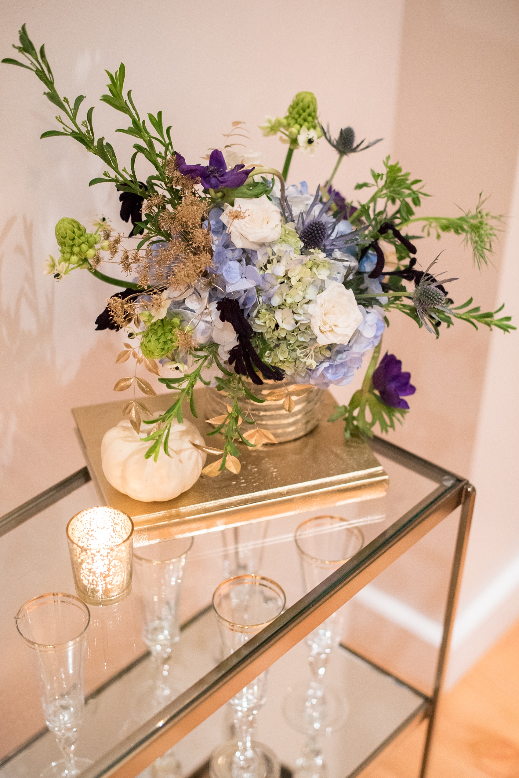 Mikkel Paige Photography photos at The Glass Box in downtown Raleigh. Fall flowers for a bookclub meeting with blue and white centerpieces by Eclectic Sage in pretty mercury glass vases.