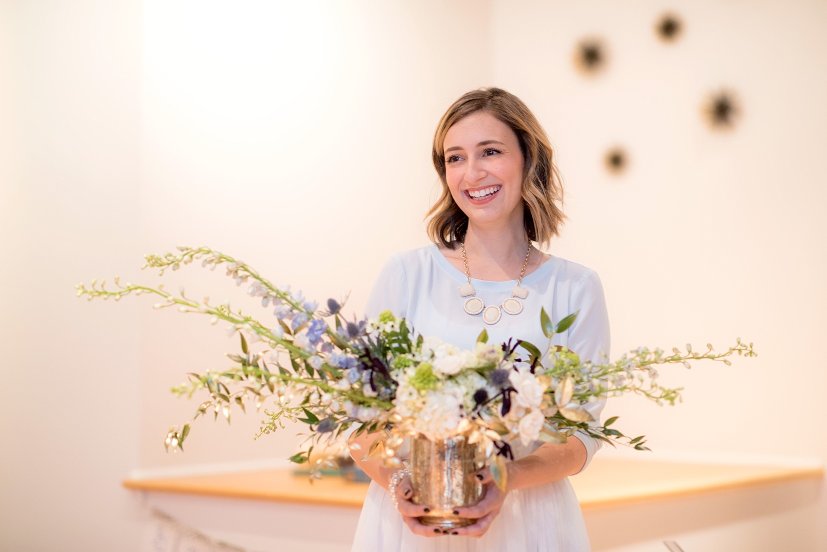 Mikkel Paige Photography photos at The Glass Box in downtown Raleigh. Fall flowers for a bookclub meeting with blue and white centerpieces by Eclectic Sage in pretty mercury glass vases.