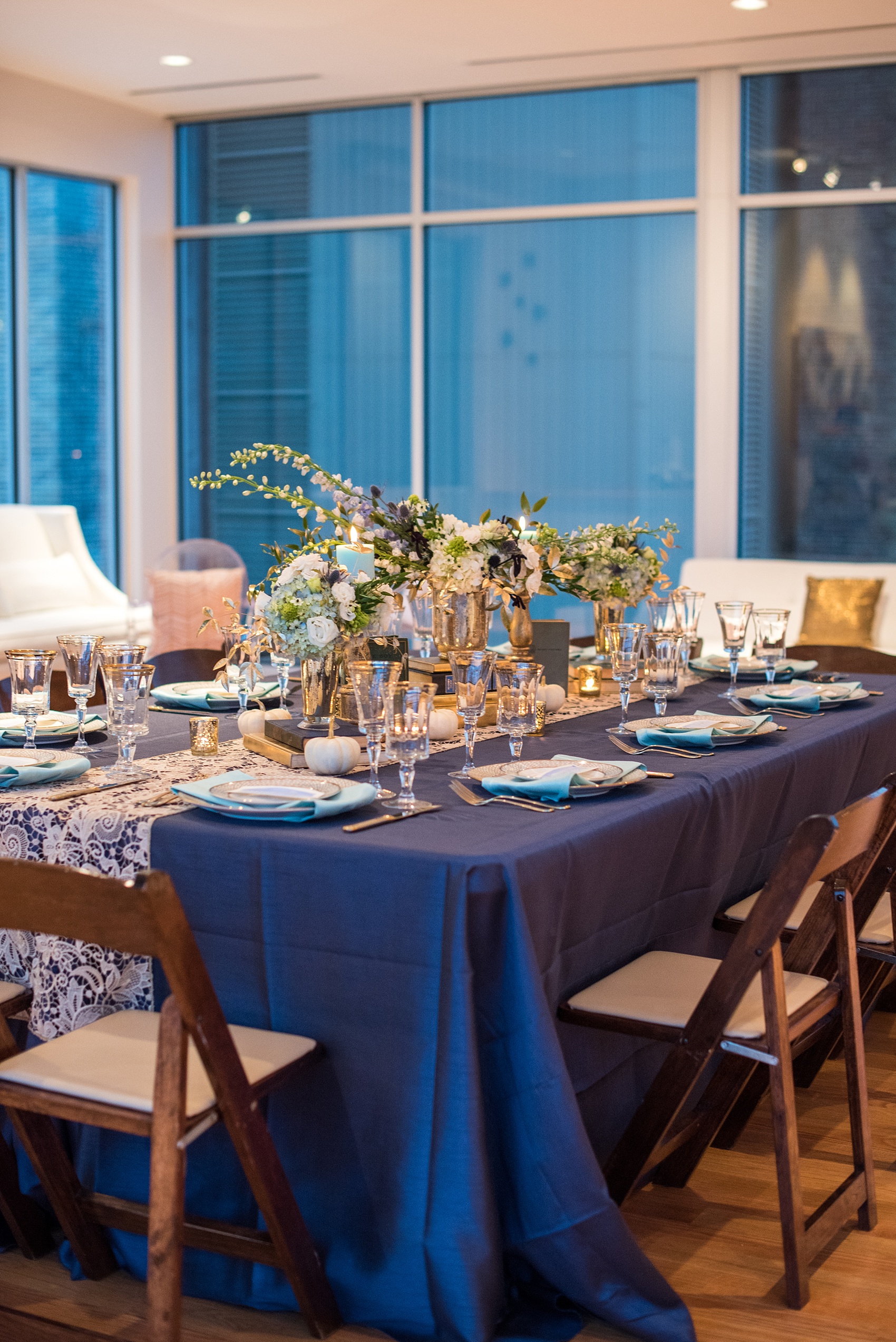 Mikkel Paige Photography photos at The Glass Box in downtown Raleigh. Fall flowers for a bookclub meeting with blue and white centerpieces by Eclectic Sage in pretty mercury glass vases.