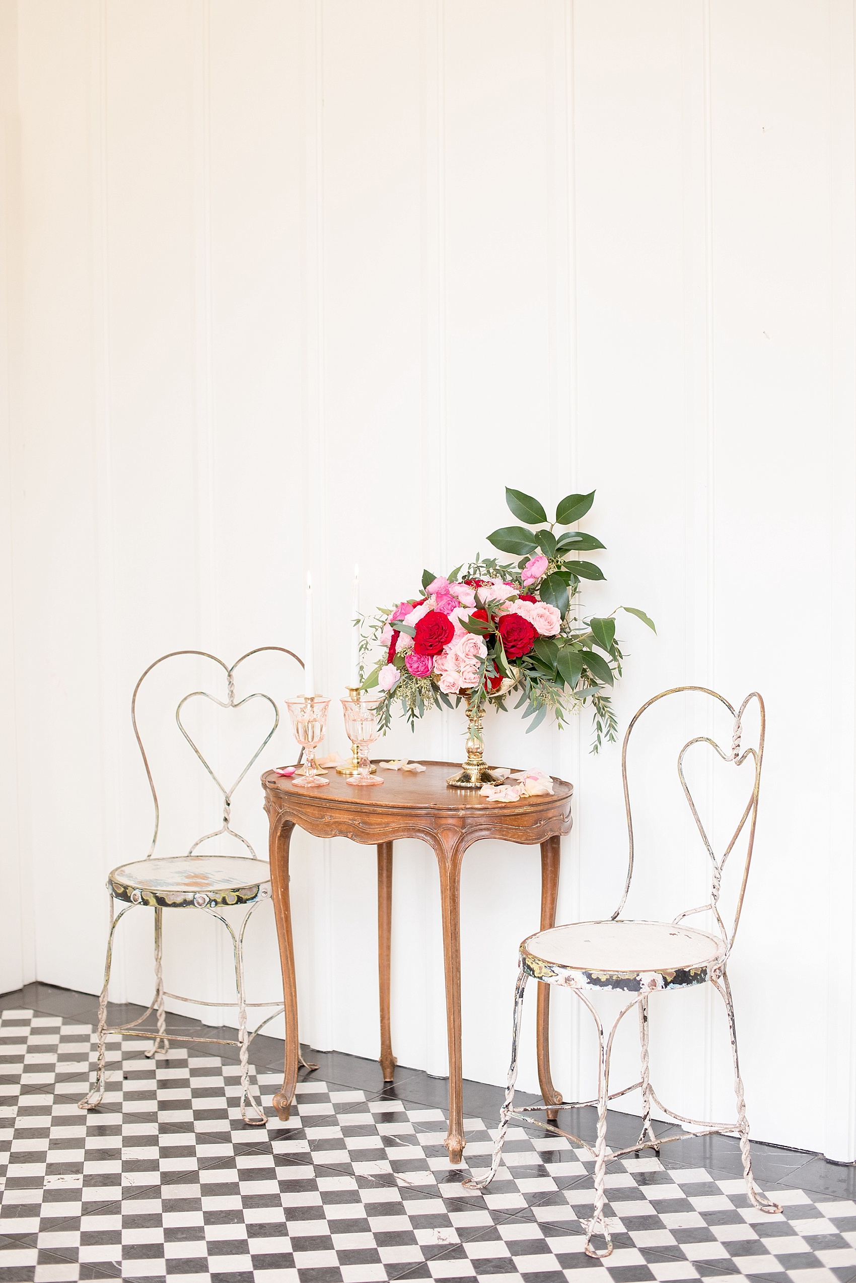 All Saints Chapel Raleigh bridal photos with an inspirational tea for Valentine's Day with pink and red flowers, heart chairs from Greenhouse Picker Sisters and colored glasses.