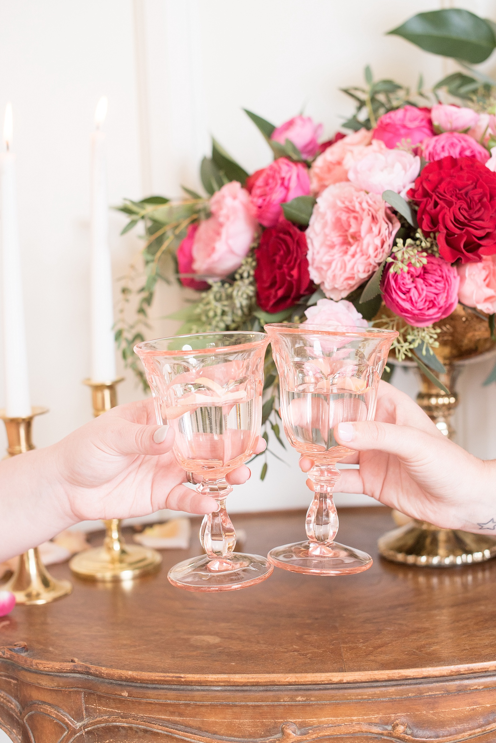 All Saints Chapel Raleigh bridal photos with an inspirational tea for Valentine's Day with pink and red flowers, and colored glasses.