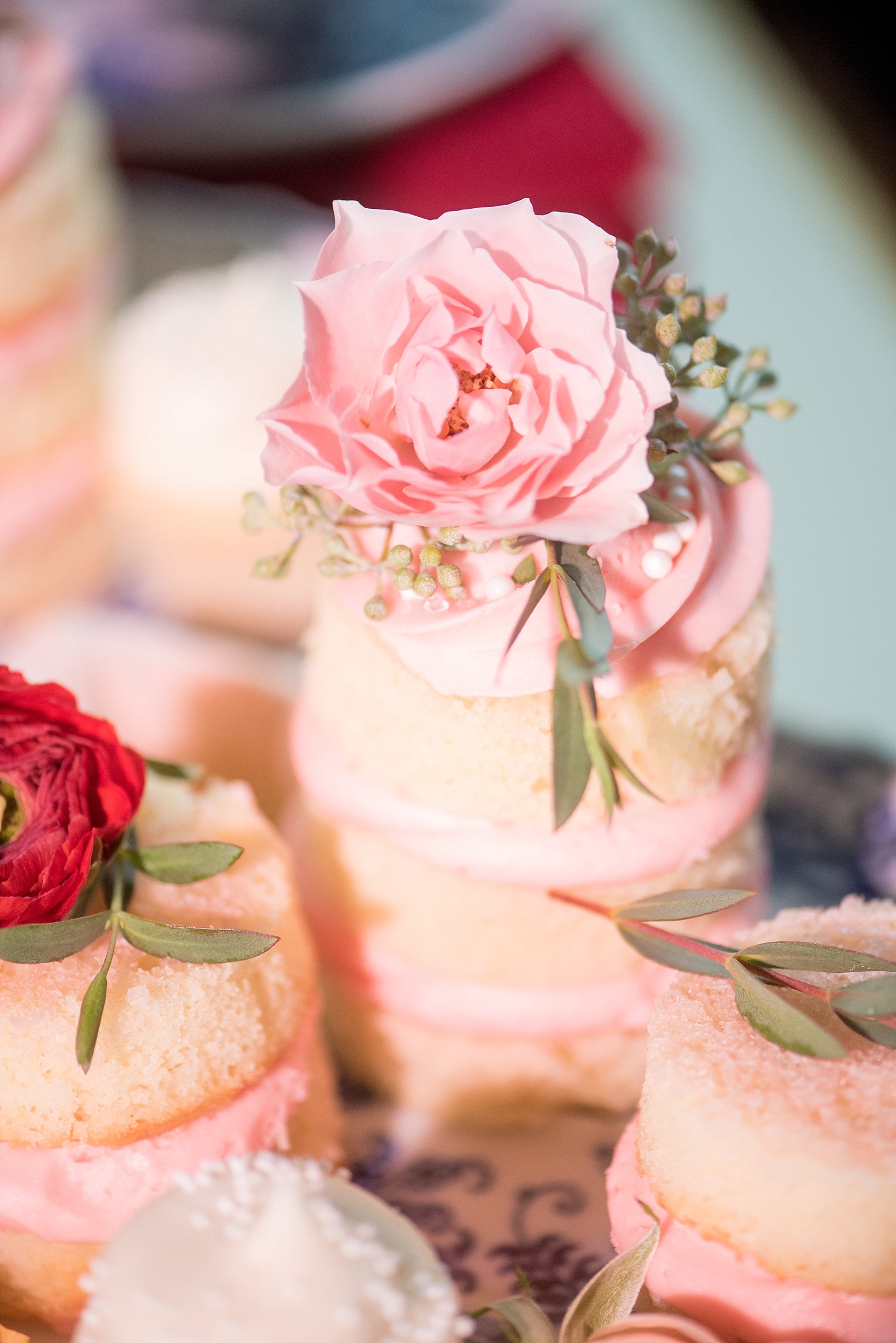 All Saints Chapel Raleigh bridal photos with an inspirational tea for Galentine's Day with pink and red cakelets.