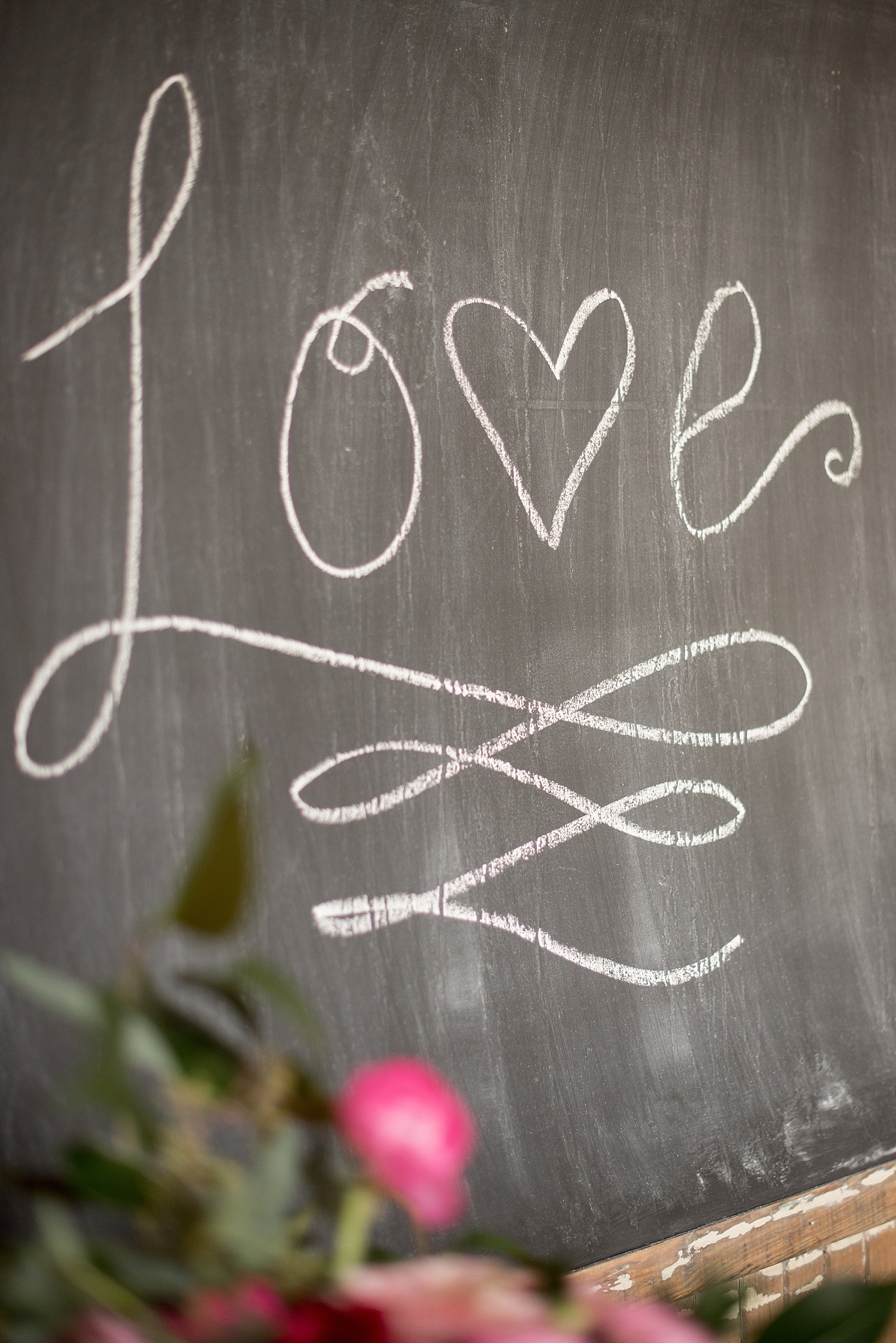 All Saints Chapel Raleigh bridal photos with an inspirational tea for Galentine's Day with "Love" in script on the chalkboard.