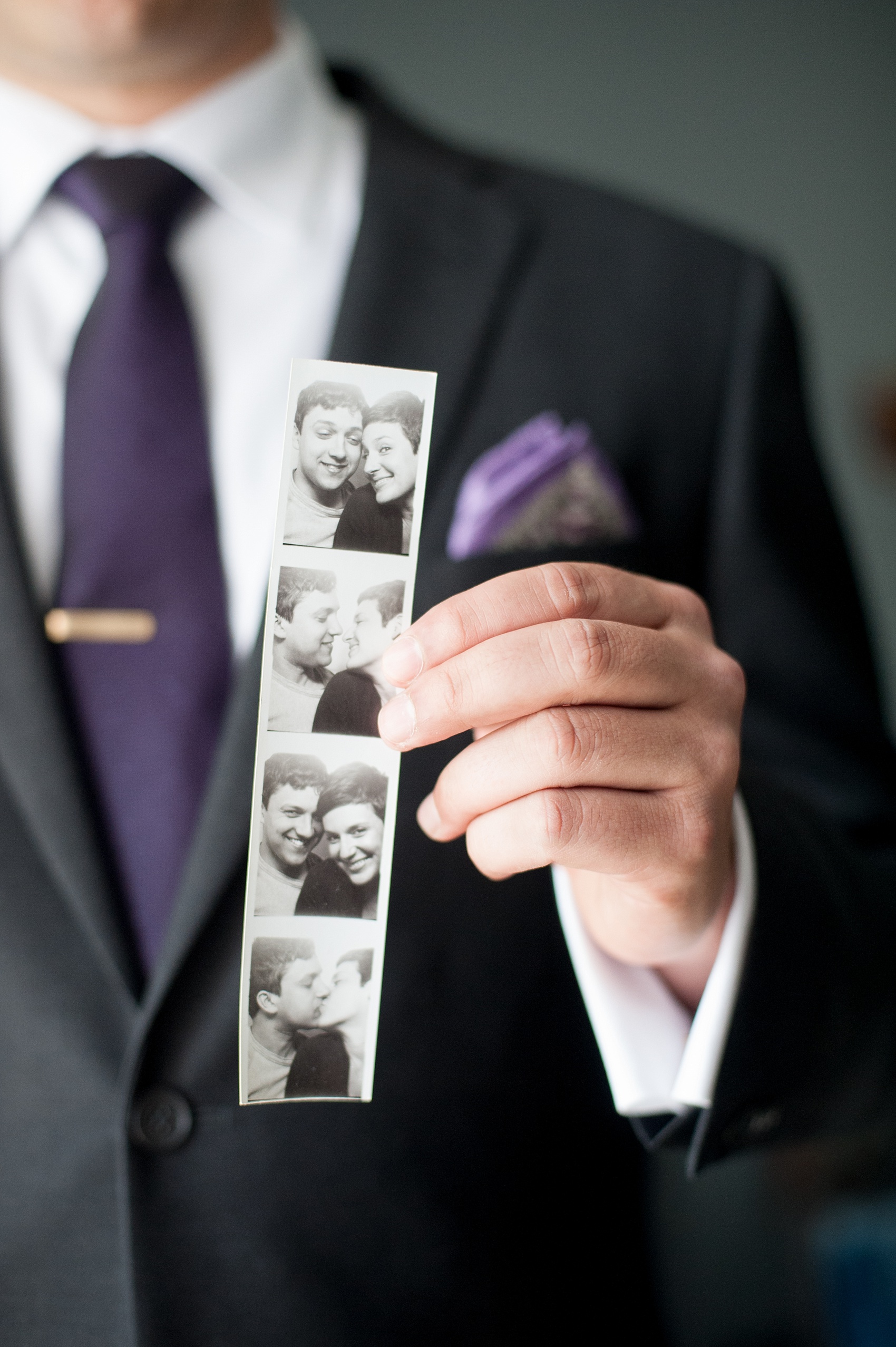 Mikkel Paige Photography Brooklyn Winery wedding photos. The groom holds a black and white photo strip of pictures with his bride against deep purple jewel tones.