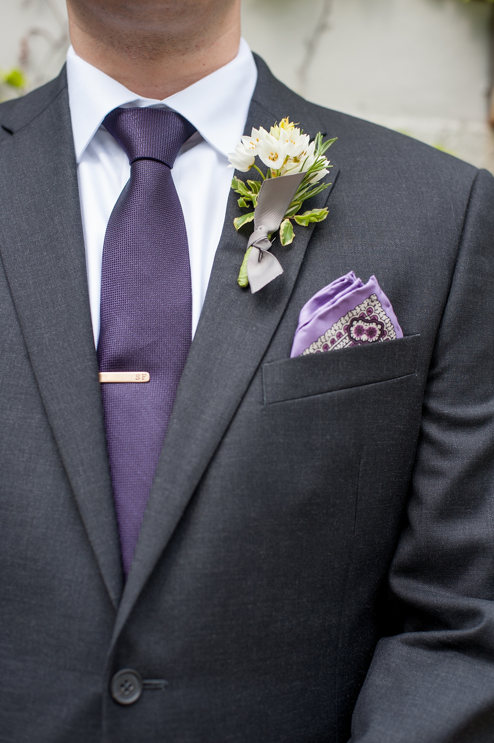 Mikkel Paige Photography Brooklyn Winery wedding photos. Detail picture of the groom in a custom suite with deep purple jewel tone tie, paisley pattern lavender pocket square and wildflower boutonniere.