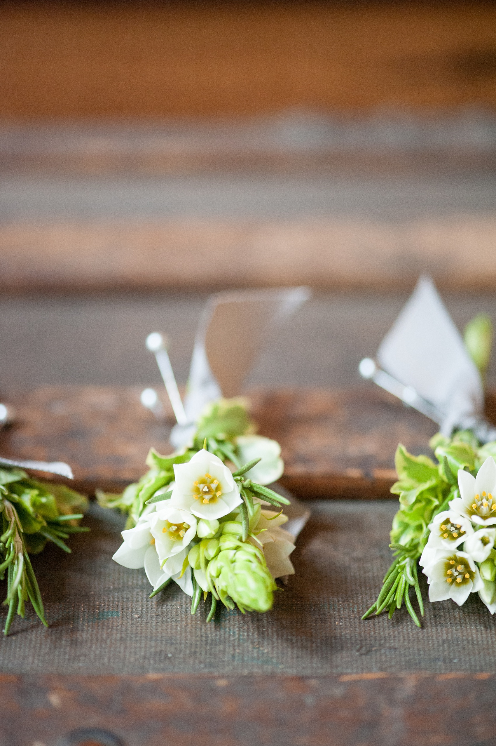 Mikkel Paige Photography Brooklyn Winery wedding photos. Detail picture of the wildflower boutonnieres tied with grey ribbon.