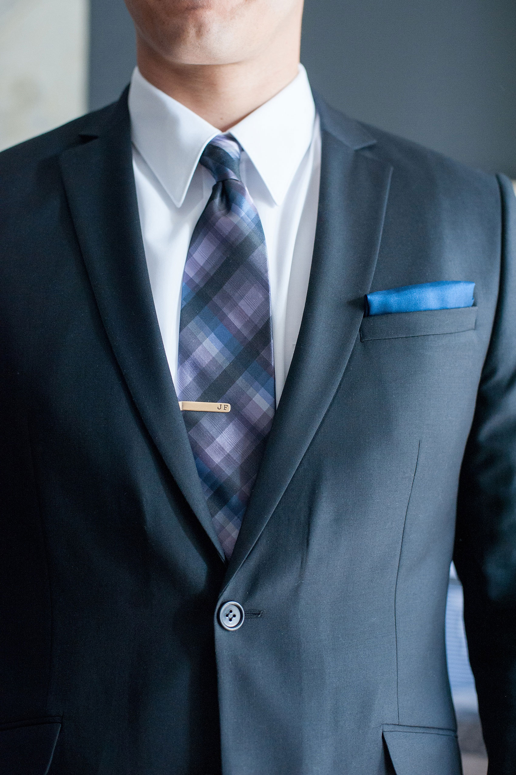 Mikkel Paige Photography Brooklyn Winery wedding photos. Picture of a groomsman suite, plaid purple and navy tie and blue pocket square.