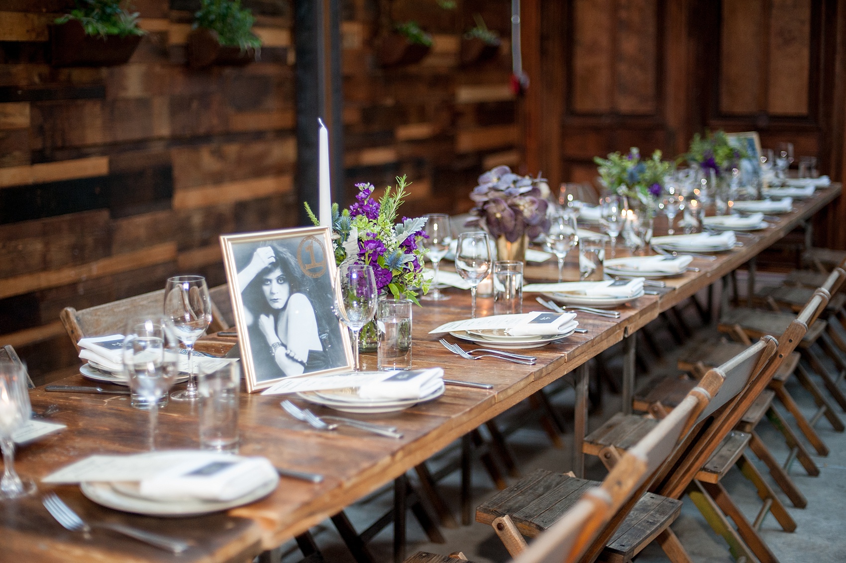 Mikkel Paige Photography Brooklyn Winery wedding photos. Picture of the wooden farm tables with purple and green floral centerpieces.