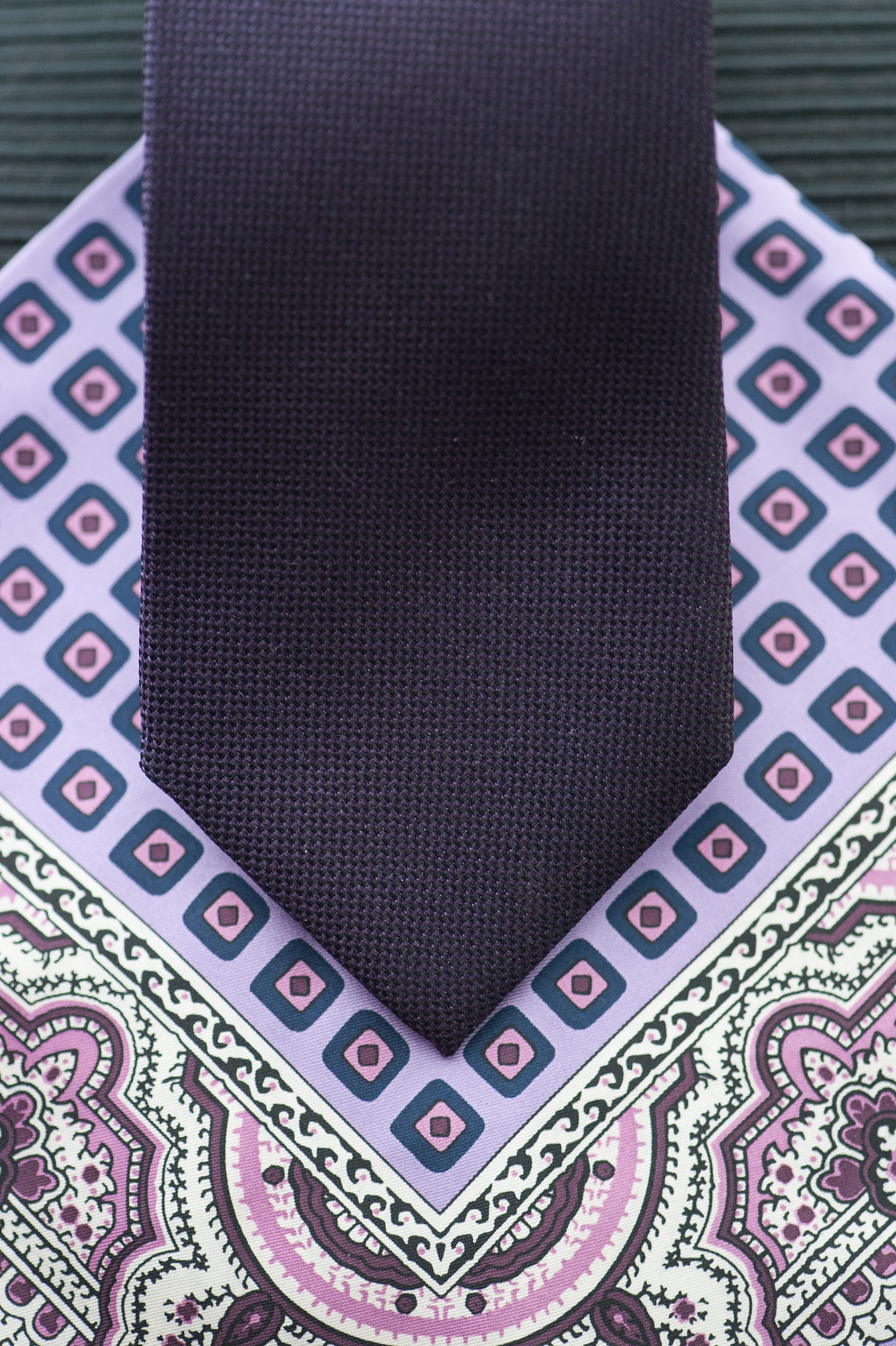 Mikkel Paige Photography Brooklyn Winery wedding photos. Detail picture of the groom's deep purple jewel-tone tie and paisley pattern lavender pocket square.