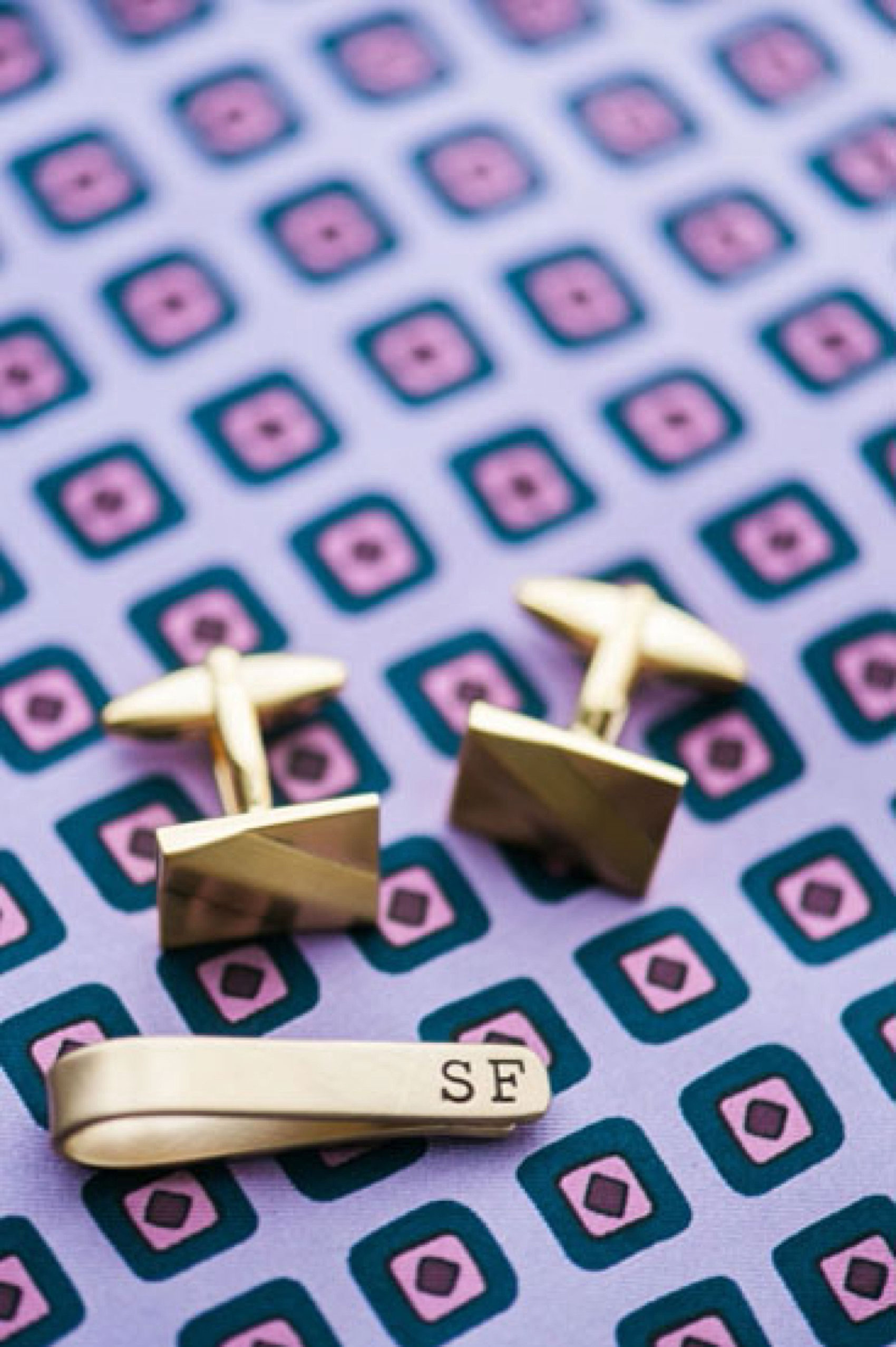 Mikkel Paige Photography Brooklyn Winery wedding photos. Detail picture of the groom's paisley pattern lavender pocket square with gold square cufflinks.