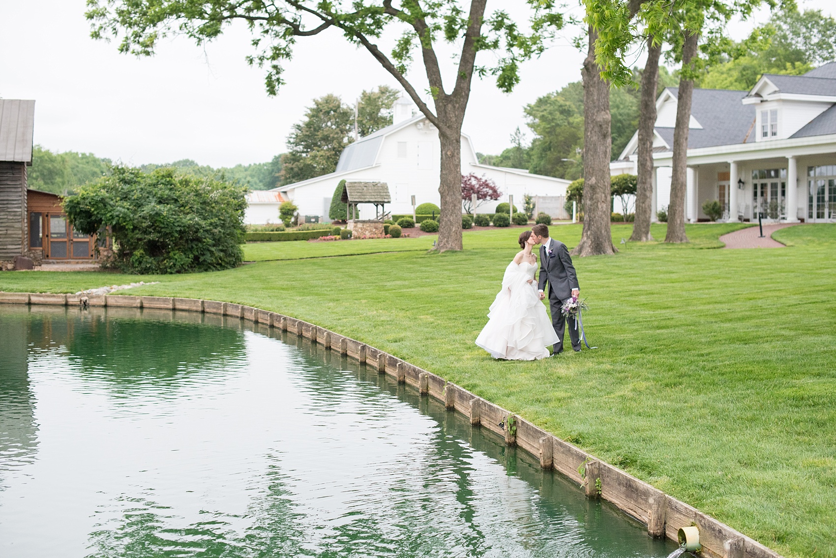 Mikkel Paige Photography images of a Rose Hill Plantation wedding inspiration. Photos of the bride and groom near the lake on the green lawn.