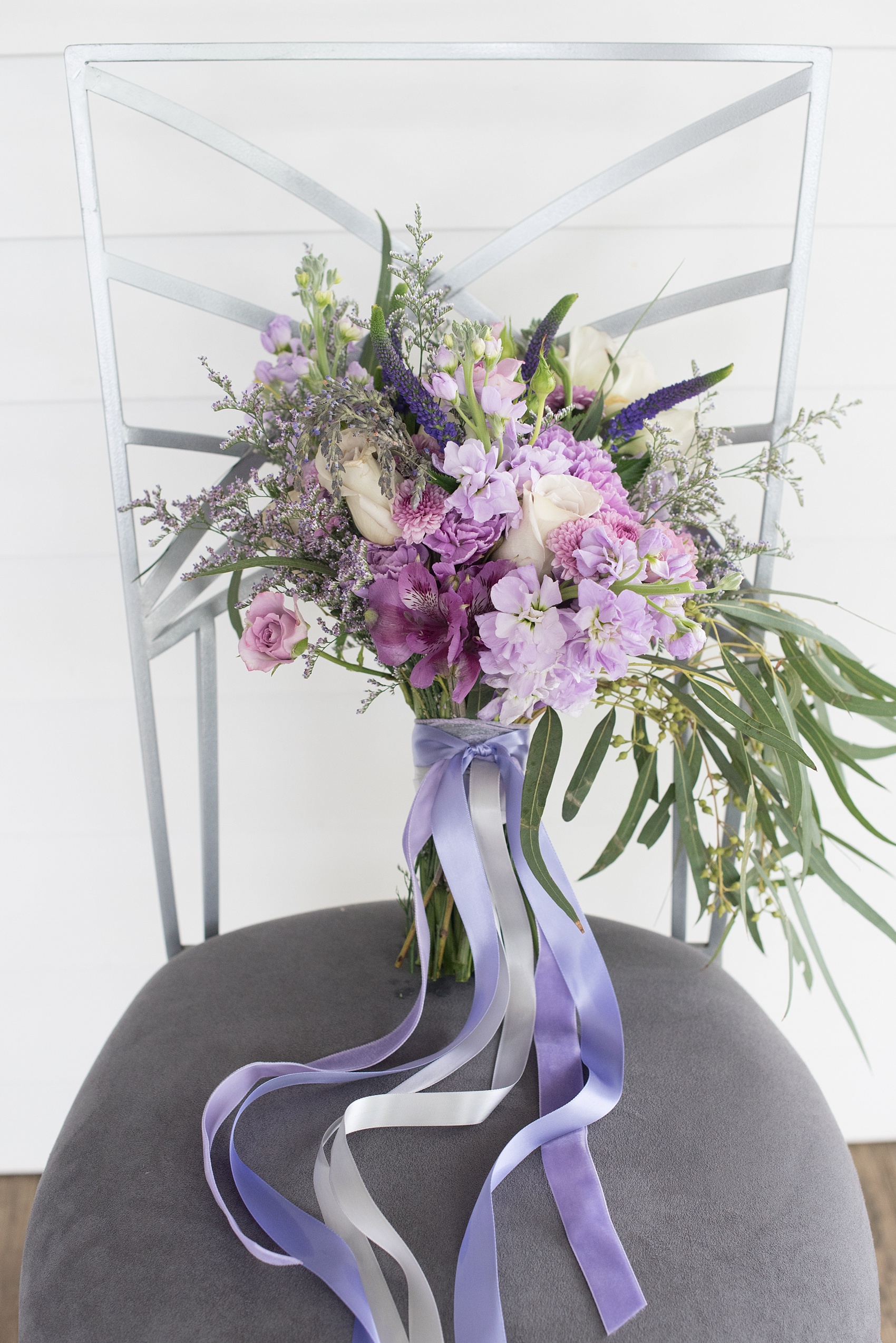 Mikkel Paige Photography images of a Rose Hill Plantation wedding inspiration. Photos of the bride's lavender and purple bouquet with long ribbons.