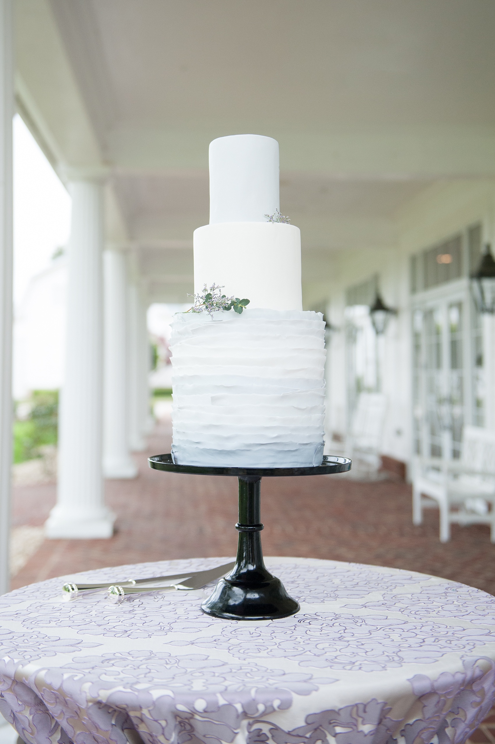 Mikkel Paige Photography images of a Rose Hill Plantation wedding inspiration. Photos of the tiered wedding cake with light purple ruffles of fondant by The Cupcake Shoppe.