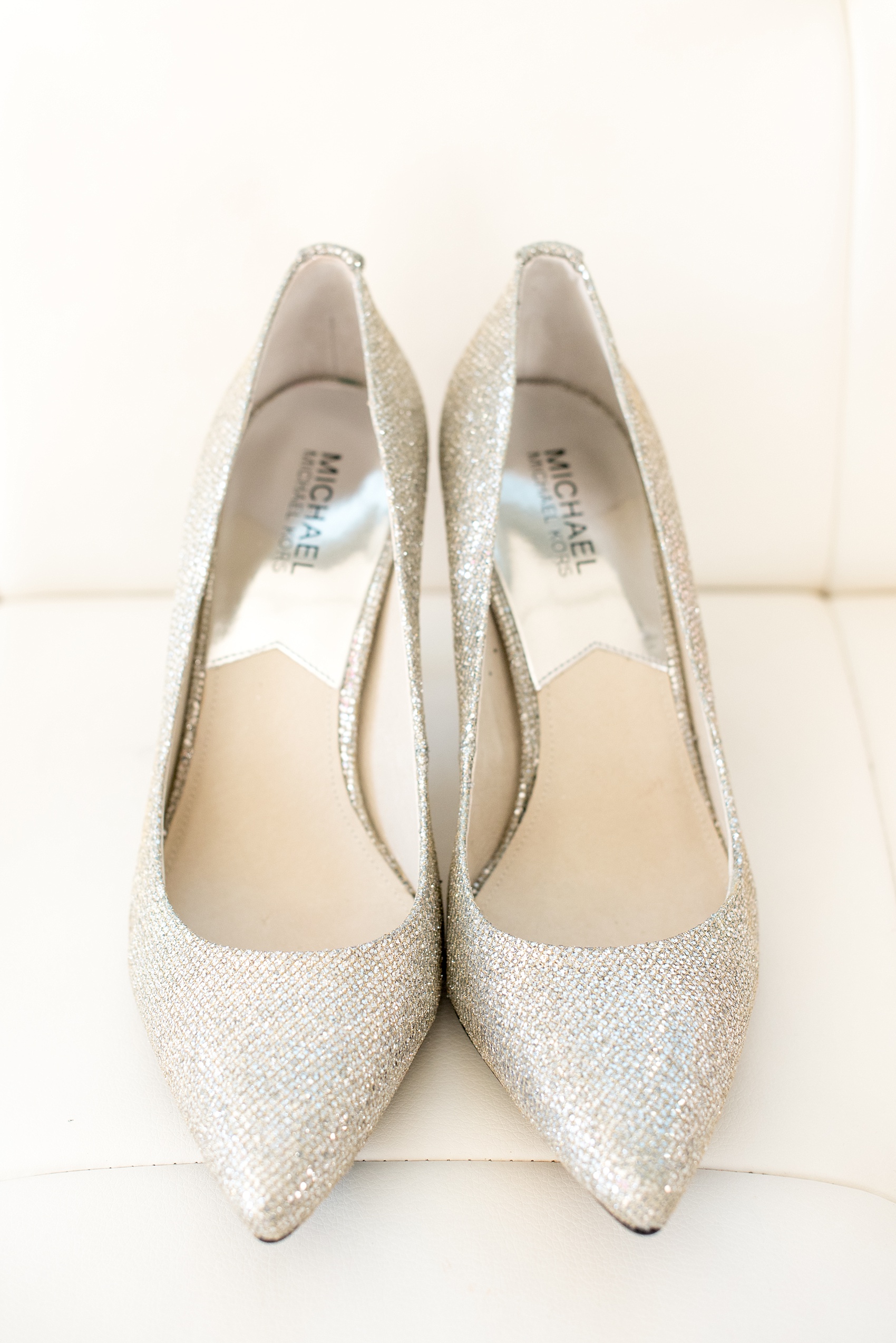 Mikkel Paige Photography photos of a small wedding at The Stockroom at 230 and The Glass Box in downtown Raleigh, North Carolina. Image of silver sparkly heels for the bride.