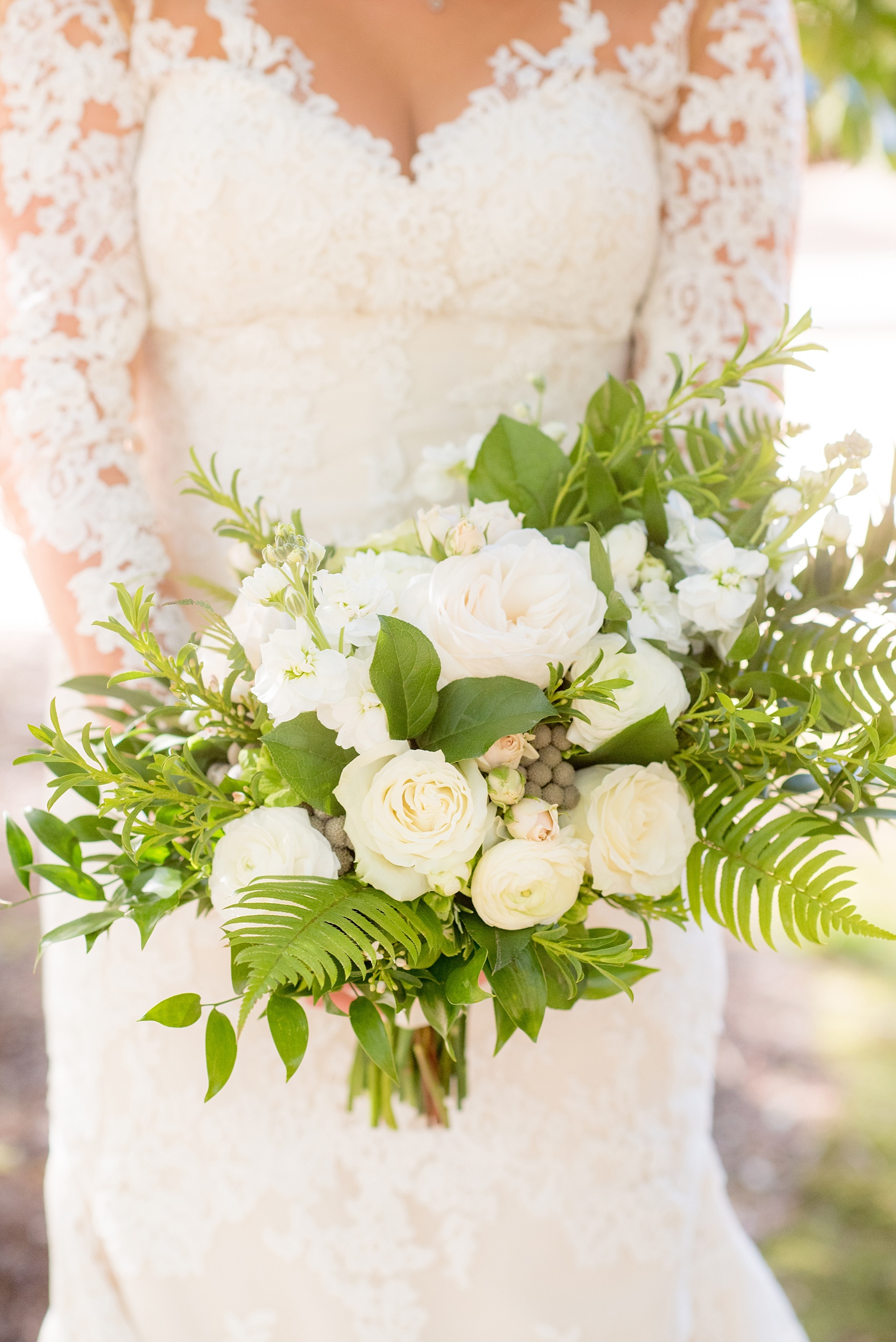 The Sutherland Wedding Photos by Mikkel Paige Photography. A picture of the bride's green and white bouquet by Eclectic Sage in her lace long-sleeve Pronovias gown.