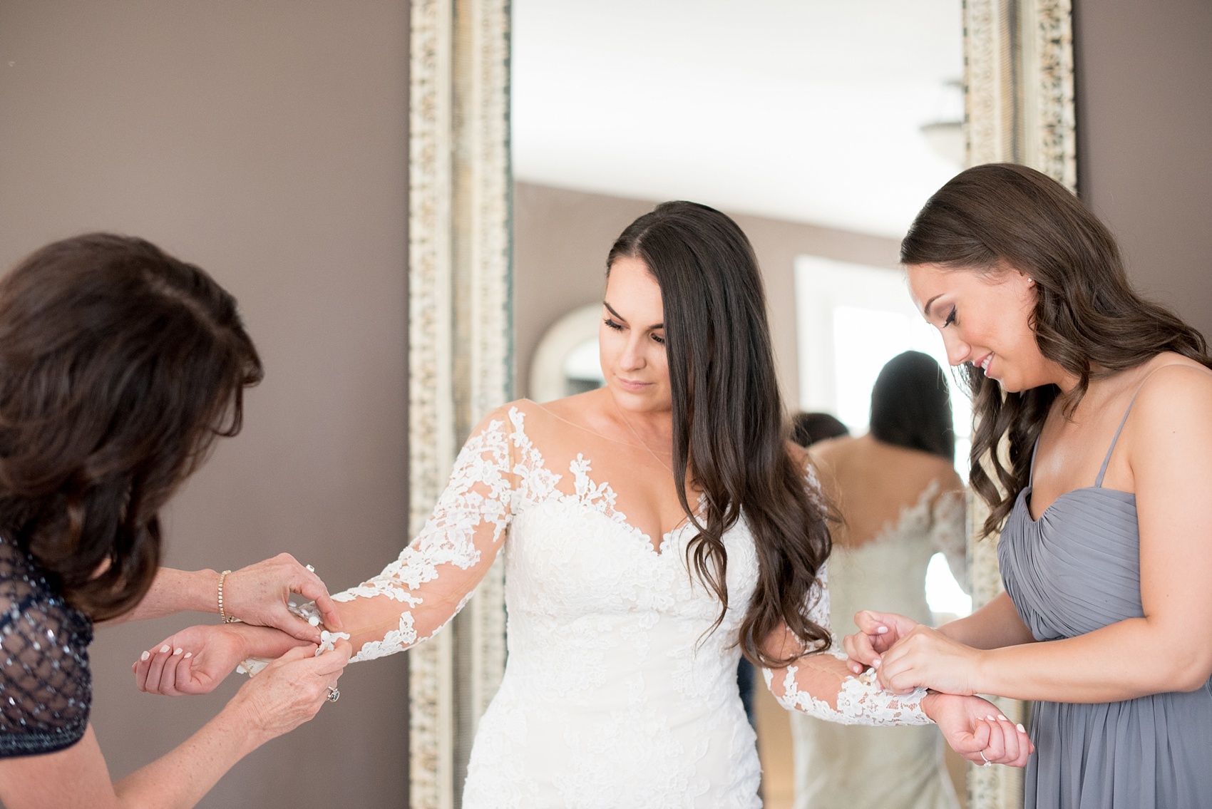 The Sutherland Wedding Photos by Mikkel Paige Photography. Picture of the bride getting ready in her lace gown a shabby chic bridal suite.