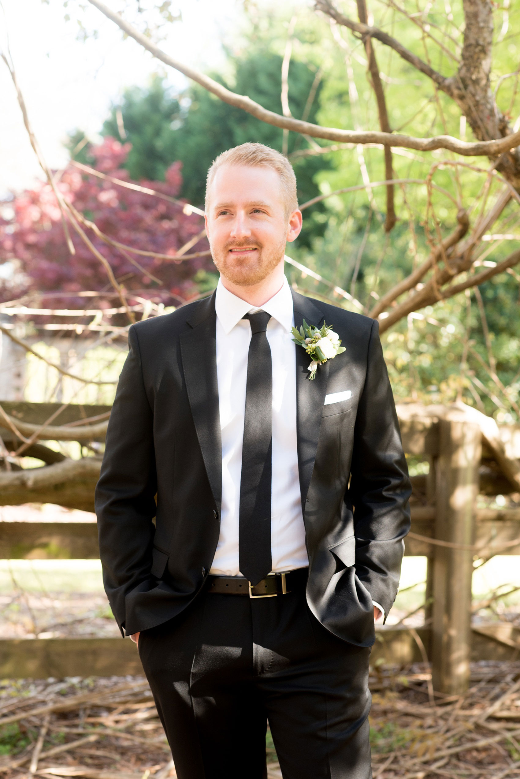 The Sutherland Wedding Photos by Mikkel Paige Photography. Picture of the groom in a classic black suit and skinny tie, and white and green boutonniere by Eclectic Sage. Planning by A Southern Soiree.