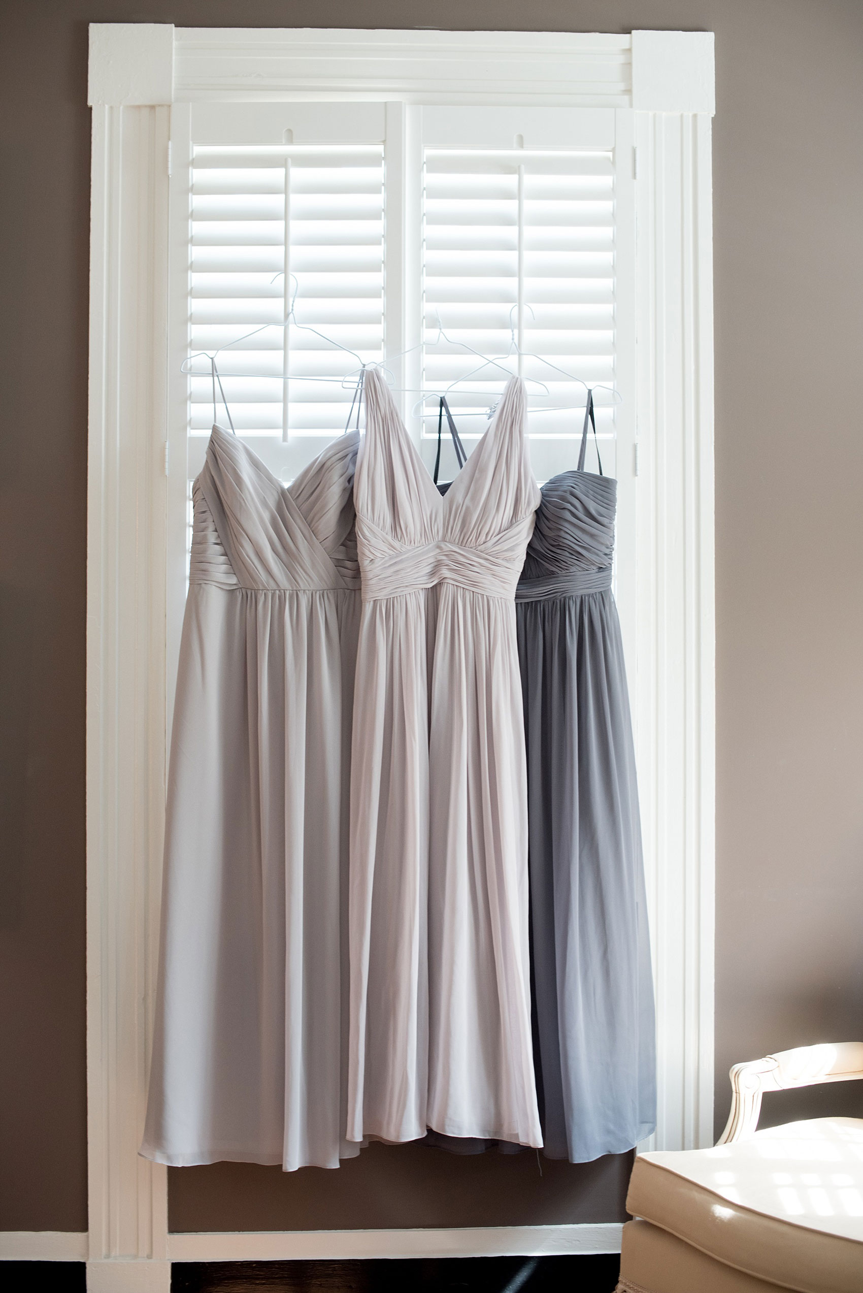 The Sutherland Wedding Photos by Mikkel Paige Photography. Detail picture of the bridesmaids gowns in various shades of grey gowns. Planning by A Southern Soiree.