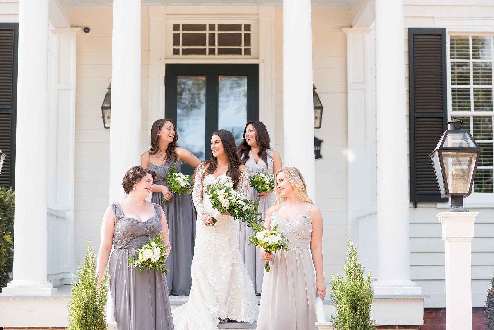 The Sutherland Wedding Photos by Mikkel Paige Photography. Vogue-like bridal party picture with the bride in lace Pronovias and bridesmaids party in various shades of grey gowns. Planning by A Southern Soiree.