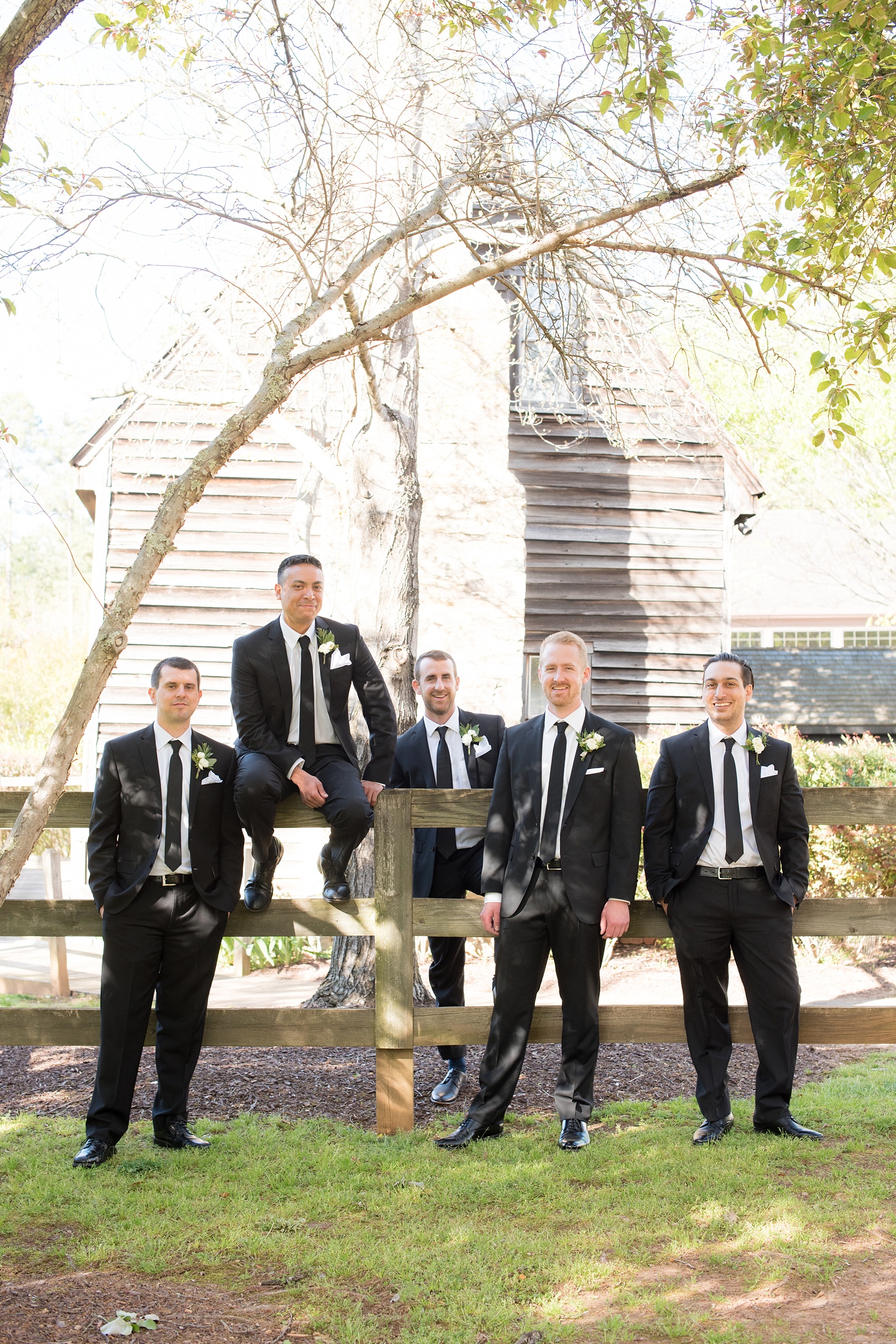 The Sutherland Wedding Photos by Mikkel Paige Photography. A fun groomsmen candid picture with the wedding party in classic black suits.